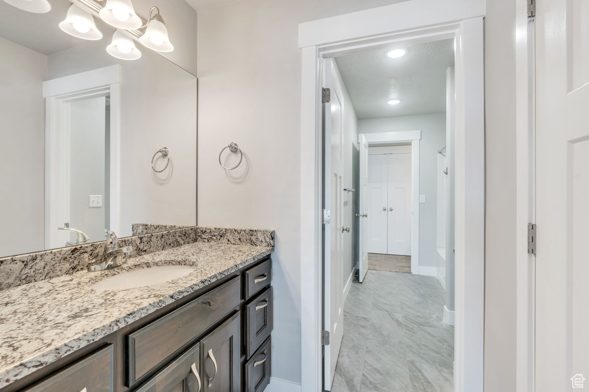 Bathroom featuring vanity and a chandelier