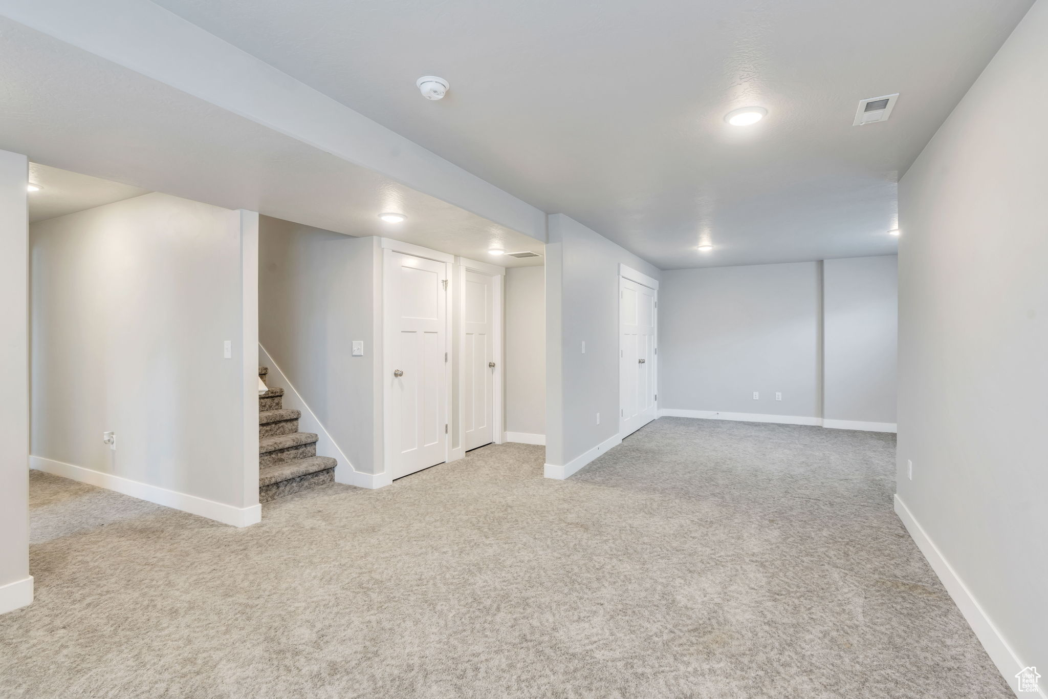 Basement with light colored carpet