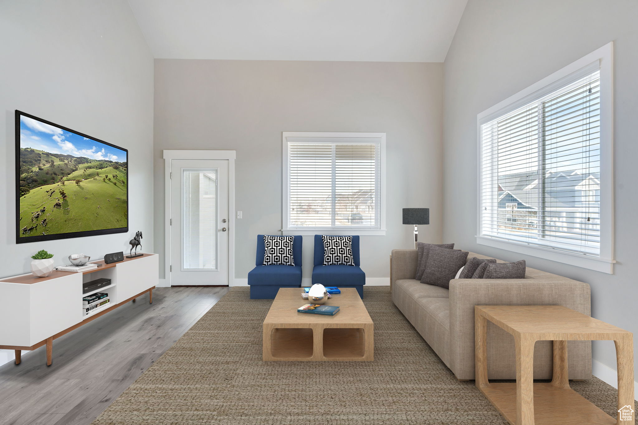 Living room featuring hardwood / wood-style flooring and lofted ceiling