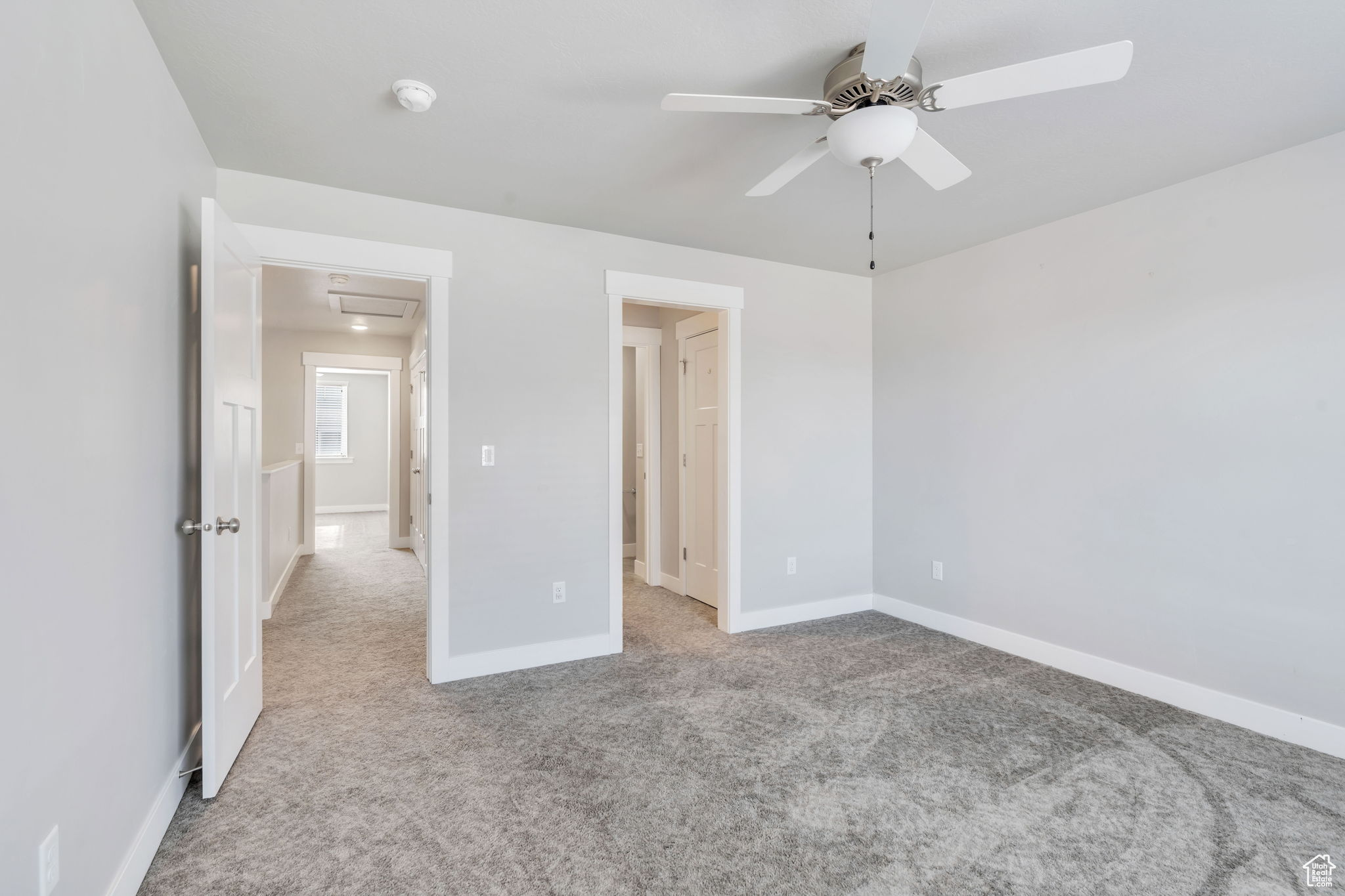 Unfurnished bedroom featuring ceiling fan and light carpet