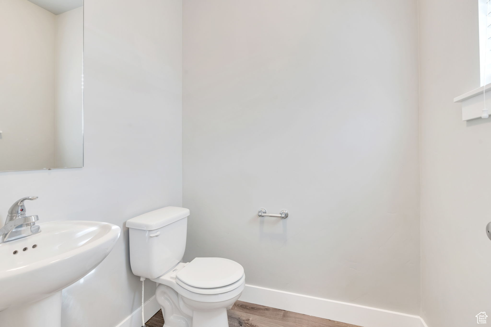 Bathroom with sink, wood-type flooring, and toilet