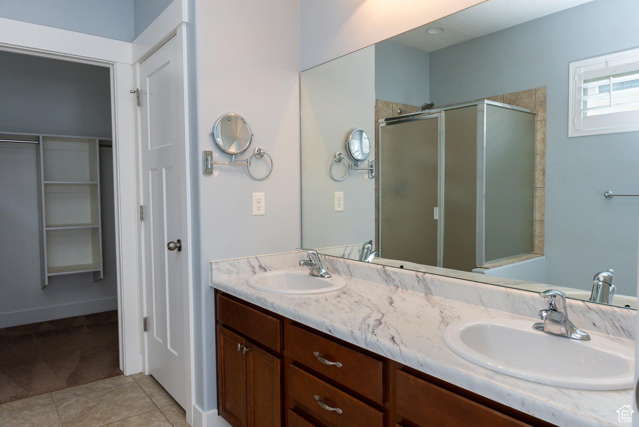 master bathroom featuring walk in shower and tub