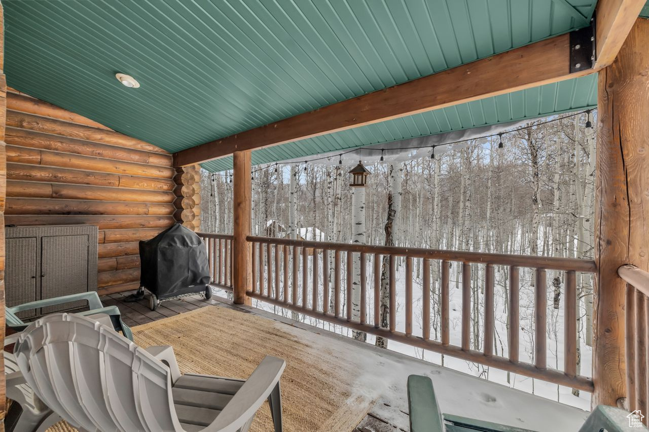 Snow covered deck with area for grilling