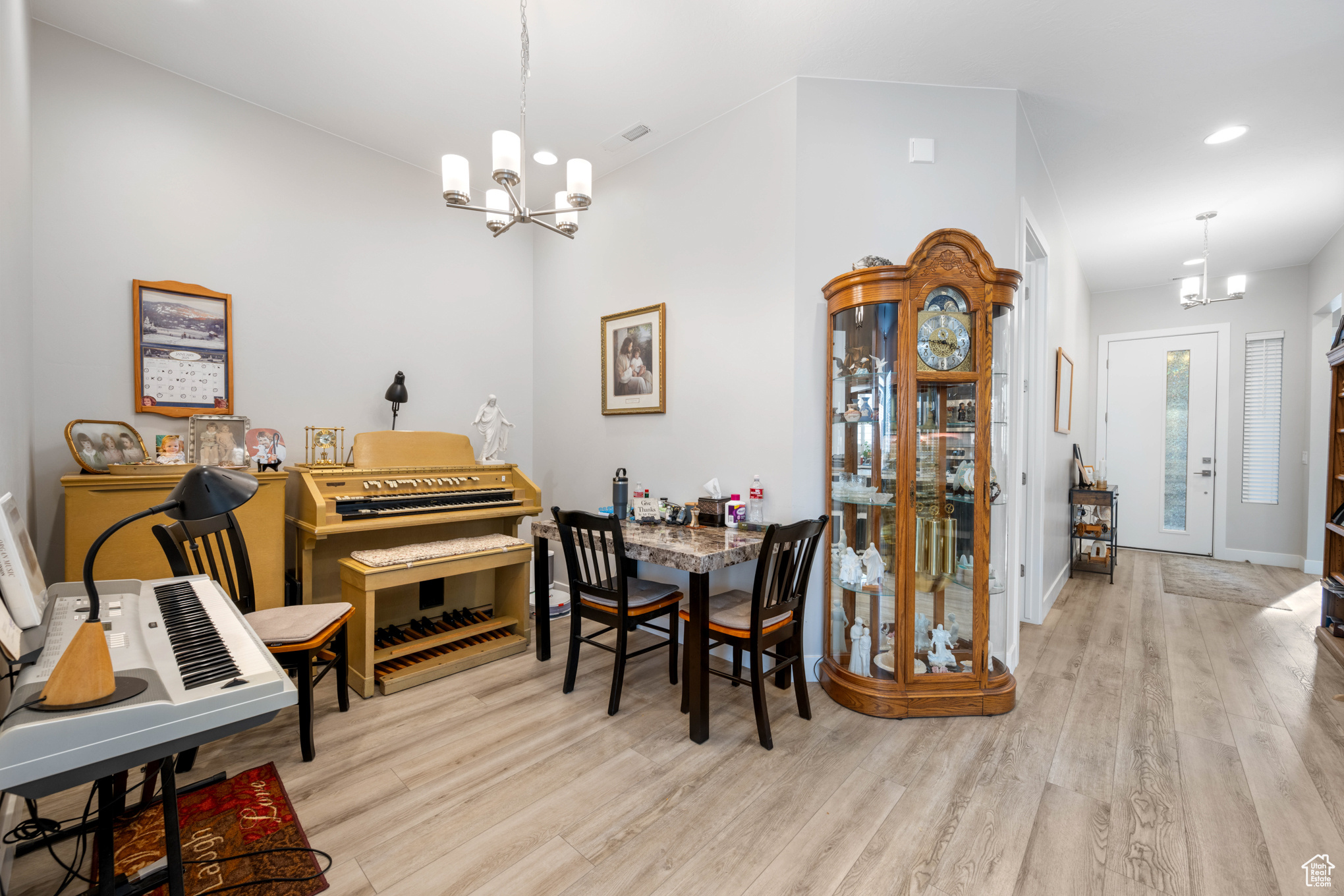 Dining space featuring light hardwood / wood-style floors and an inviting chandelier