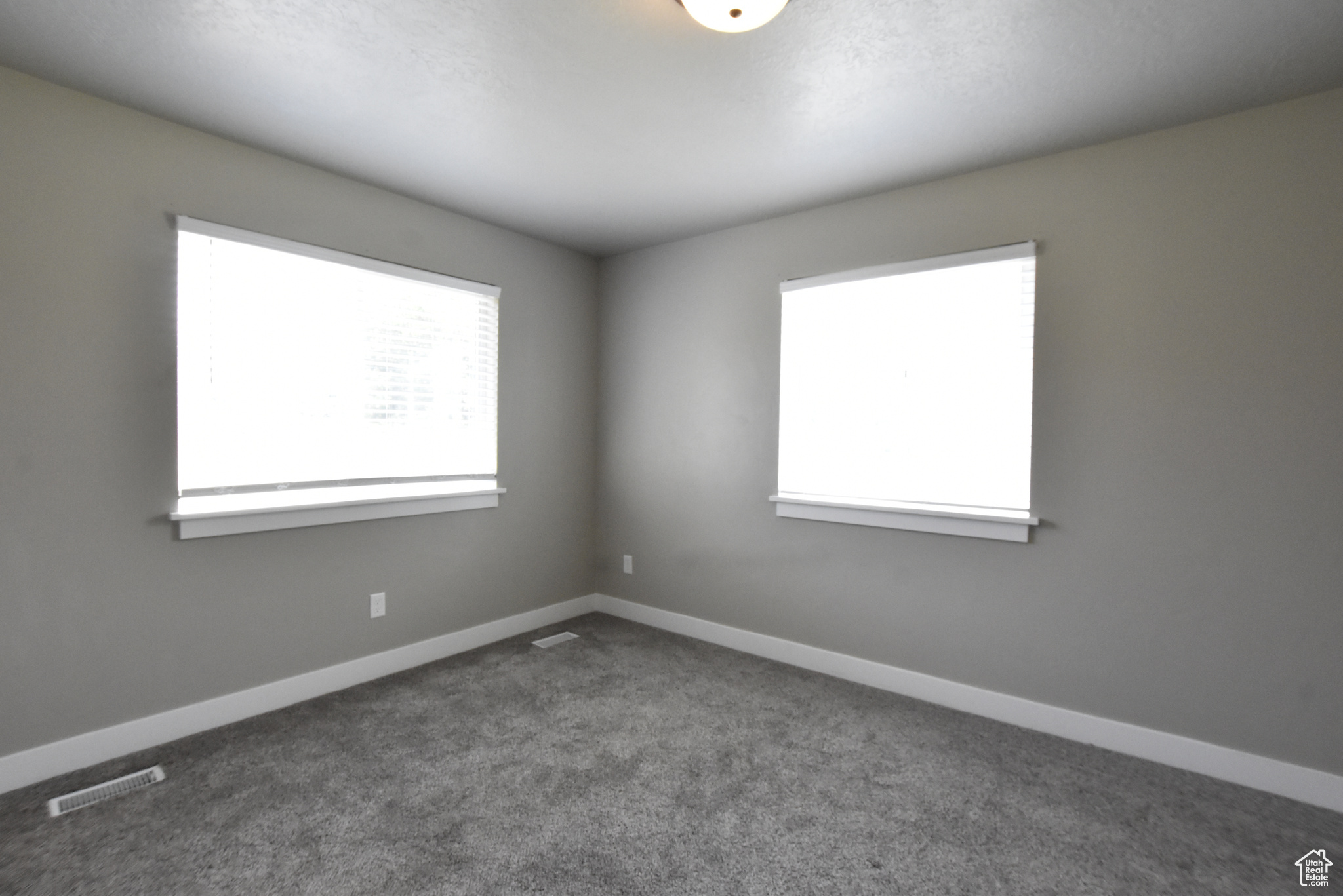 Carpeted empty room with plenty of natural light