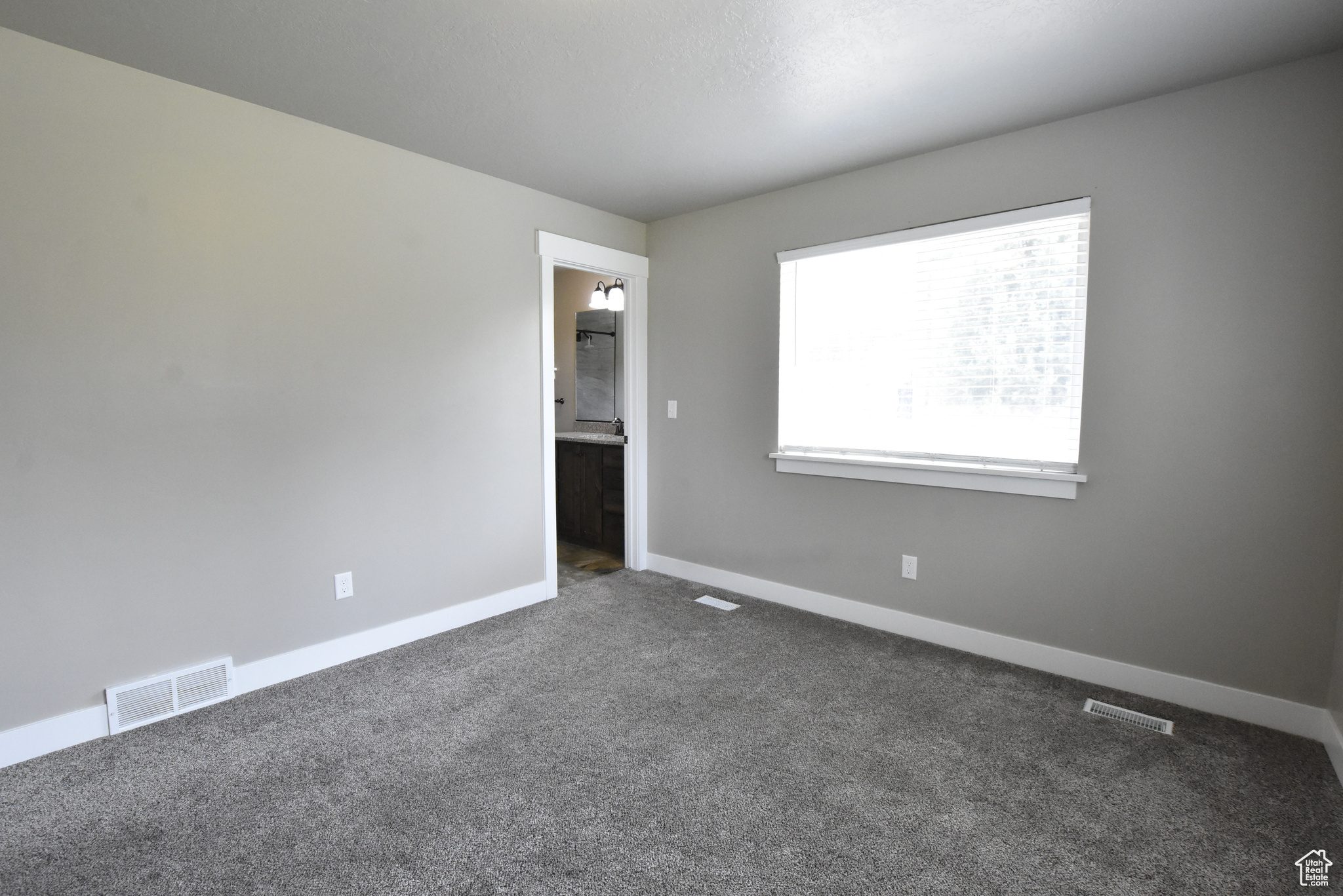 Unfurnished room with dark carpet