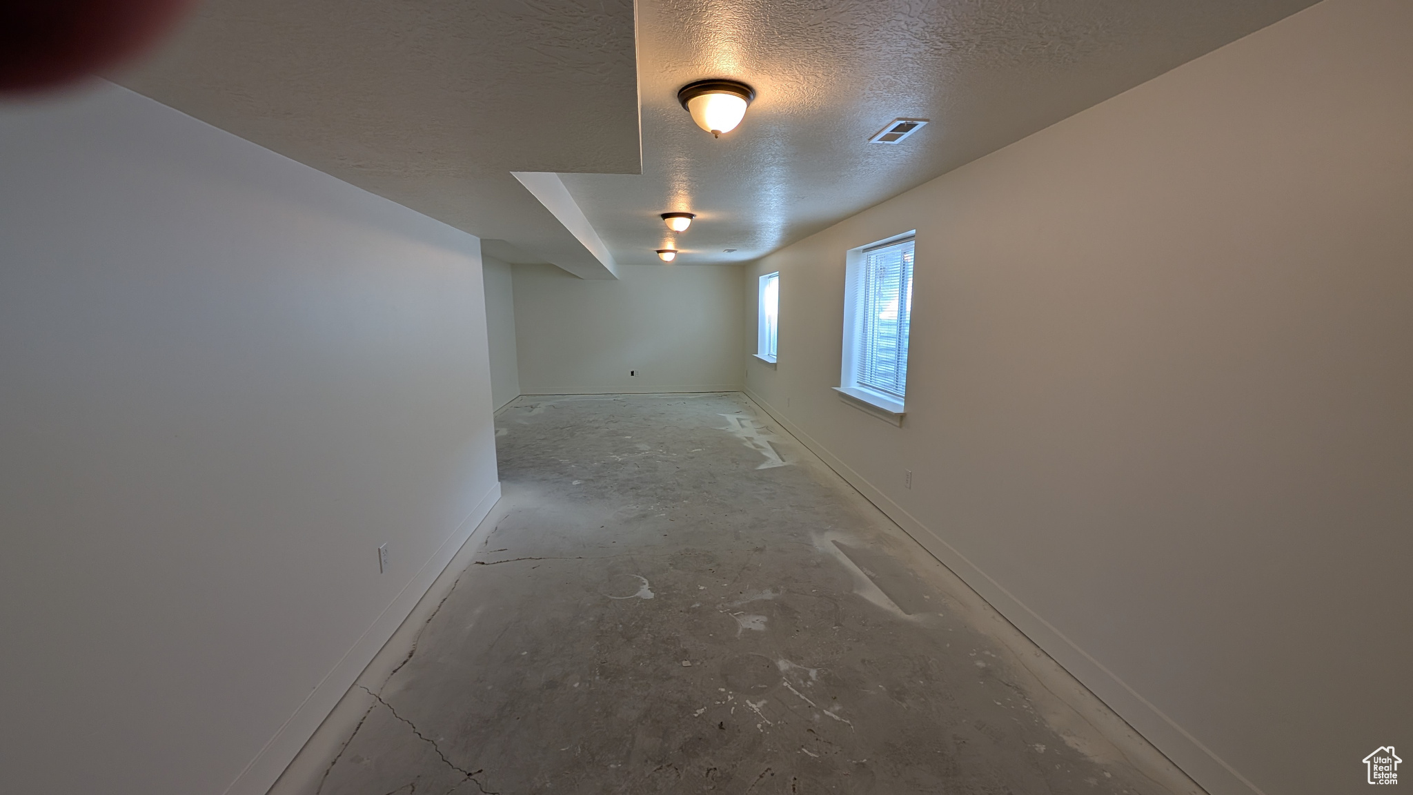 Empty room featuring a textured ceiling