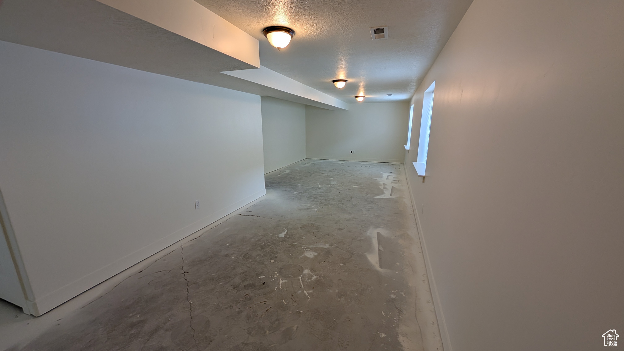 Basement with a textured ceiling
