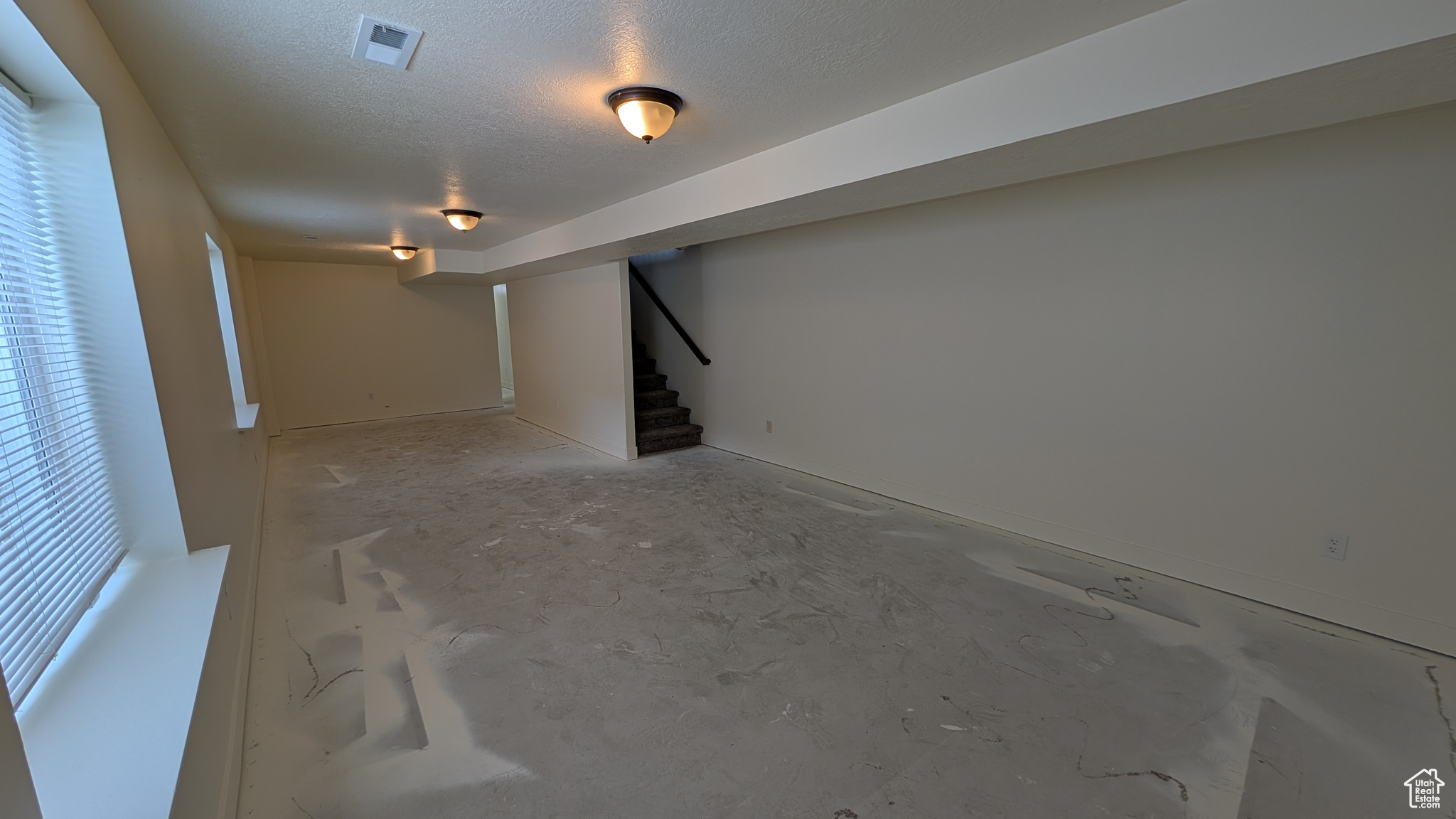 Basement featuring a textured ceiling