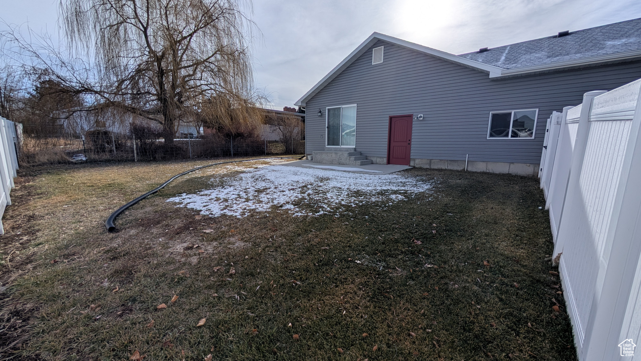 Back of property with a yard