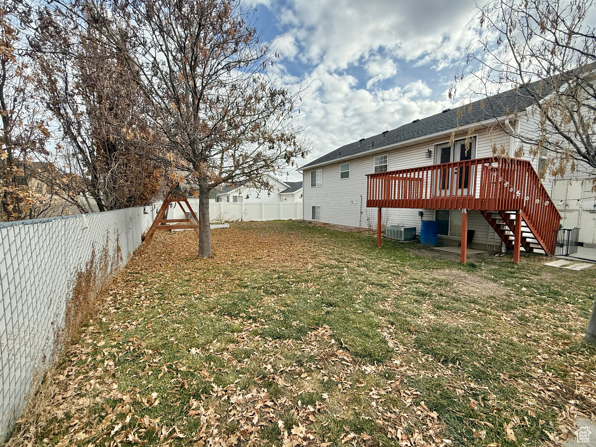 View of yard with central AC unit and a deck