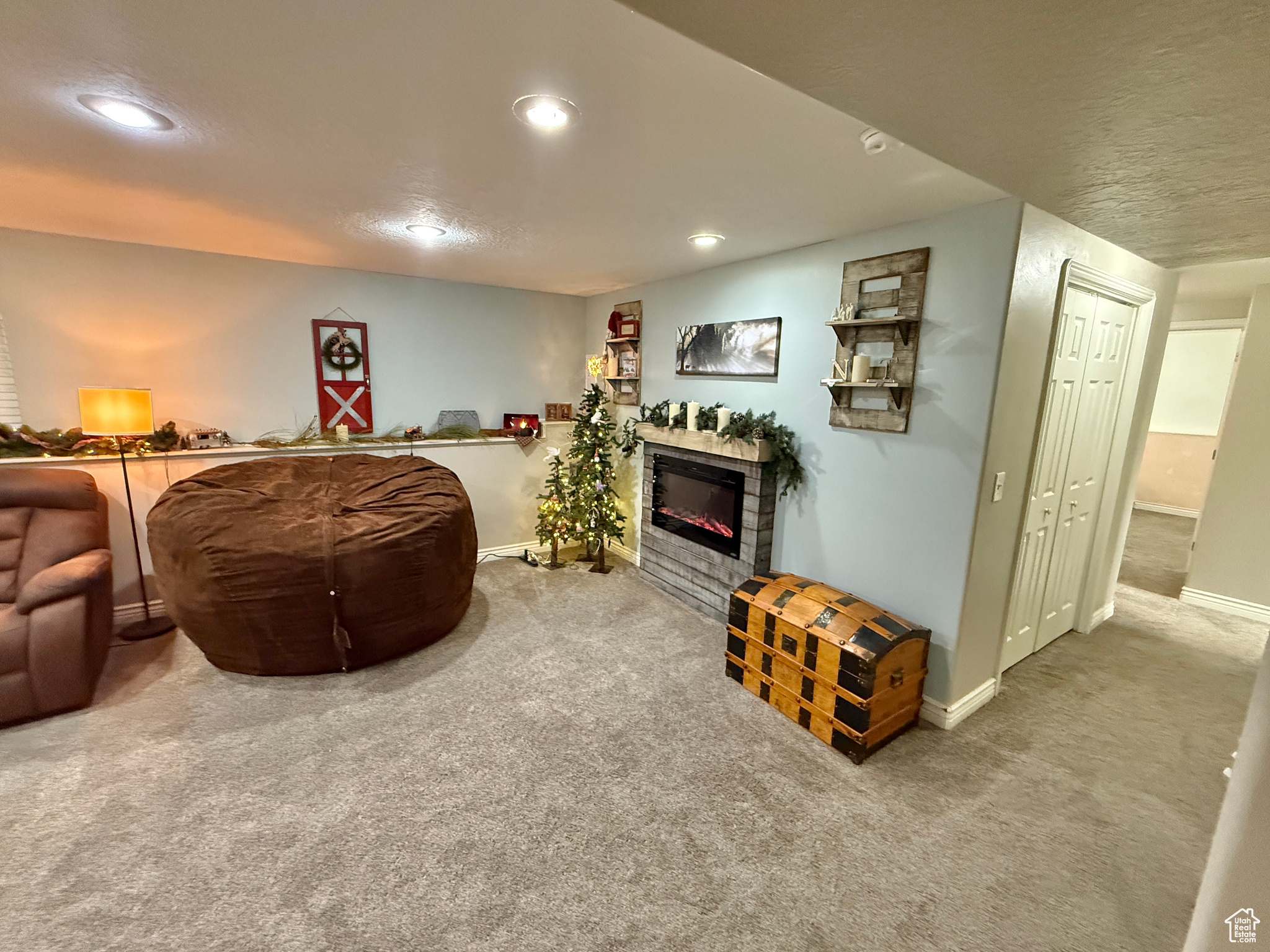 Living room with a fireplace and carpet flooring