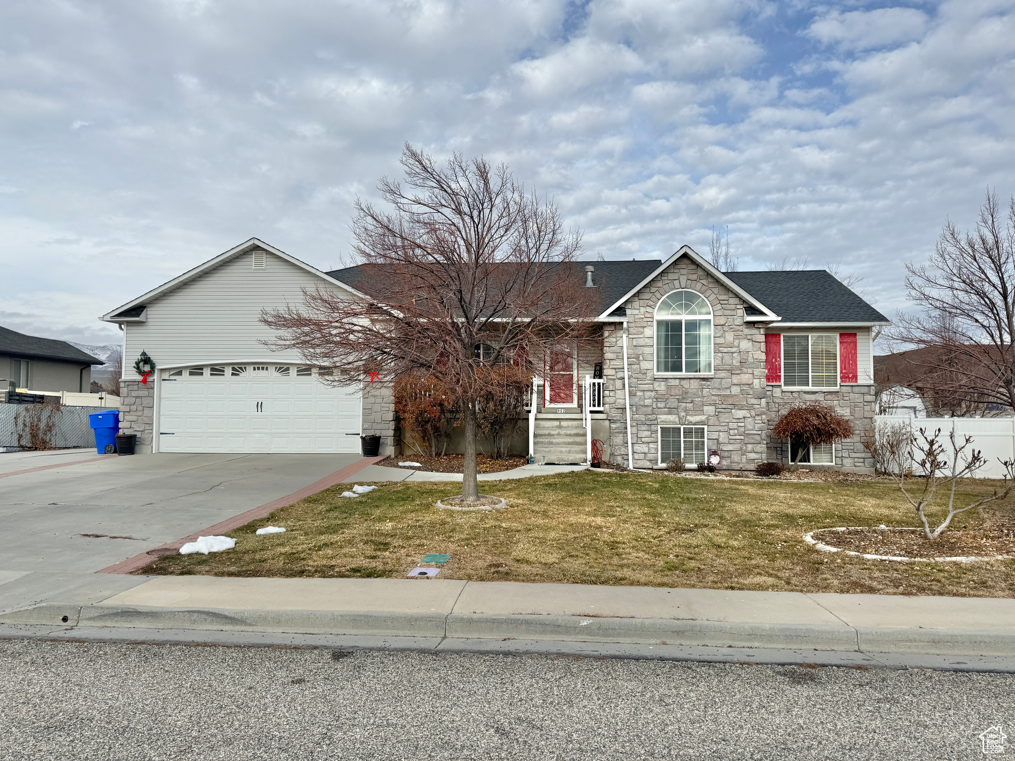 Ranch-style home with a garage and a front lawn