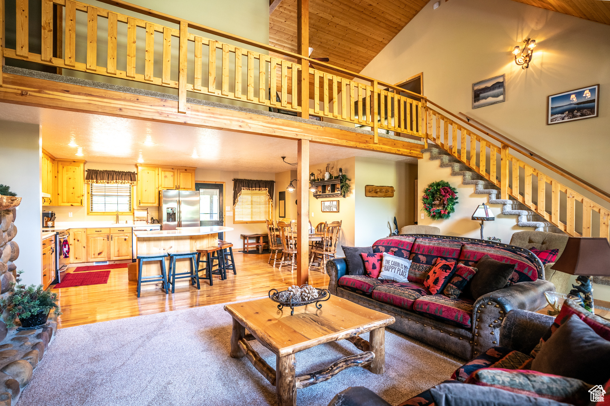 Carpeted living room featuring high vaulted ceiling and wood ceiling