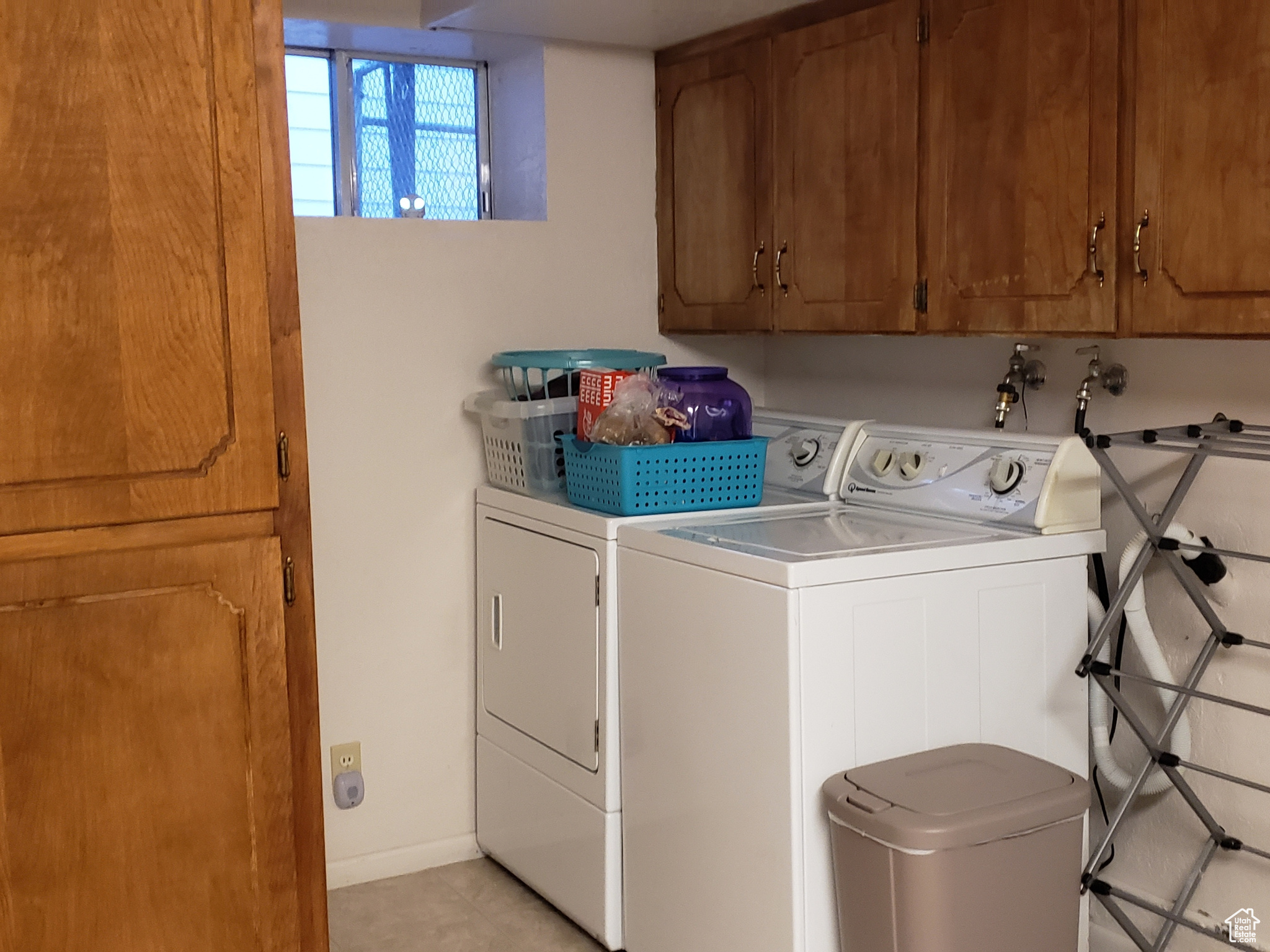Laundry area with storage cabinets.