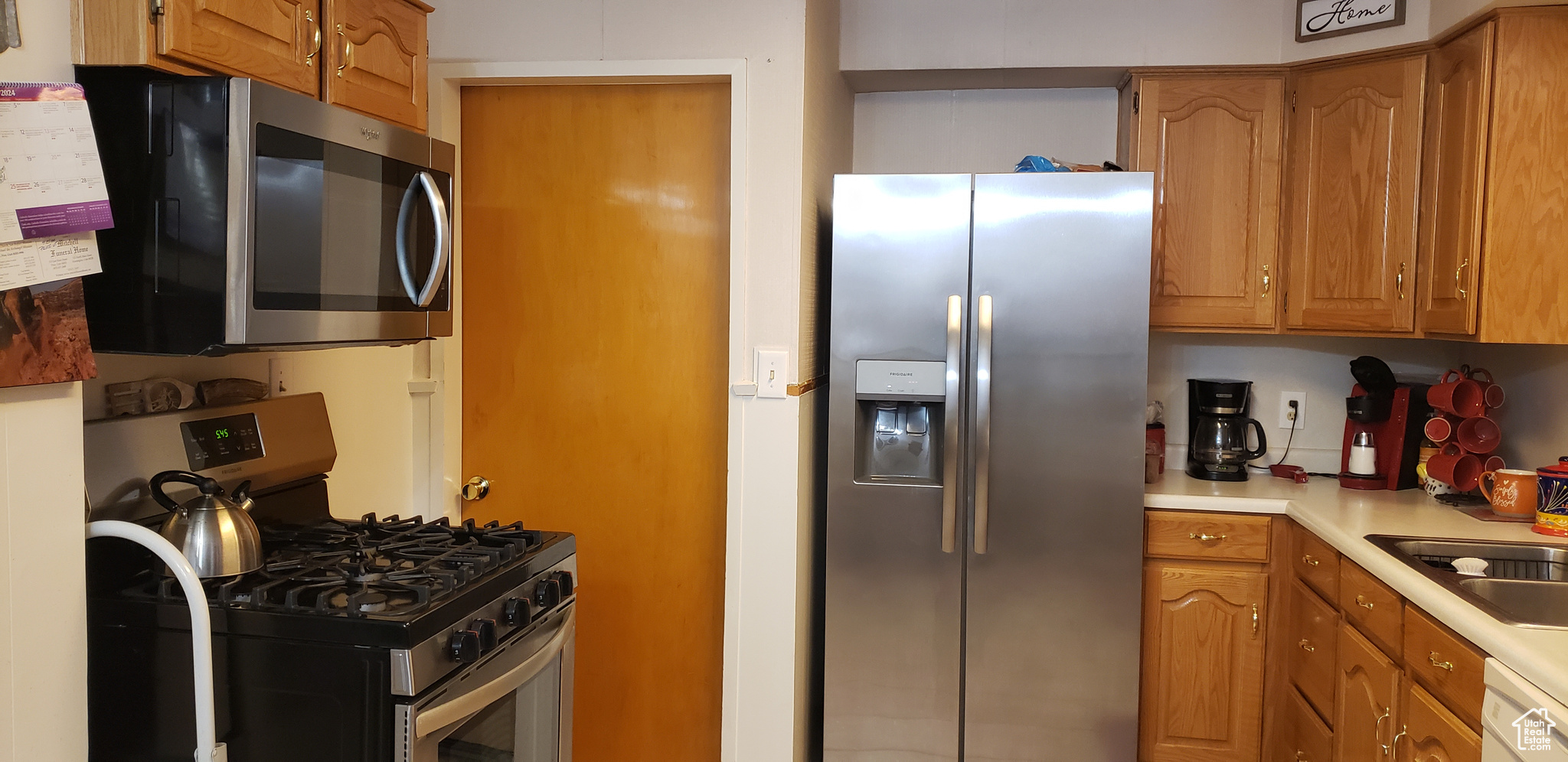 Kitchen with appliances with stainless steel finishes and sink