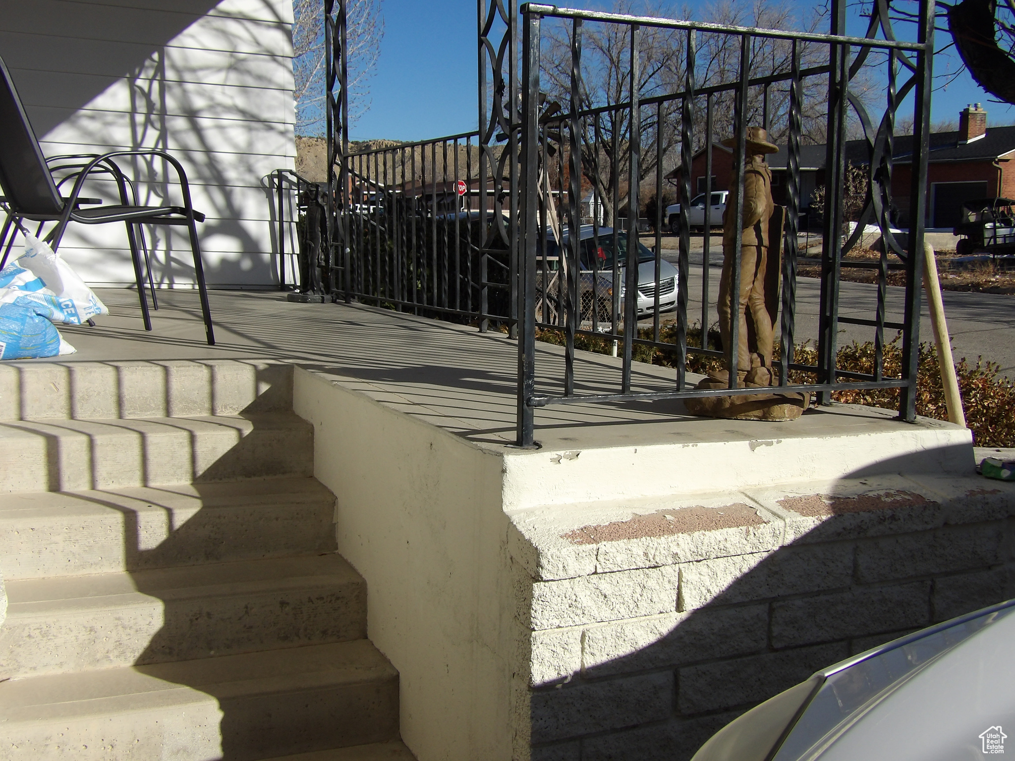 View of stairway leading to concrete driveway.