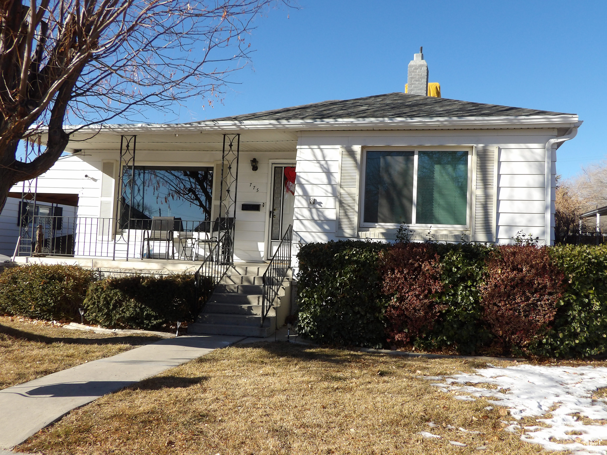 View of front of home featuring a porch and a front lawn