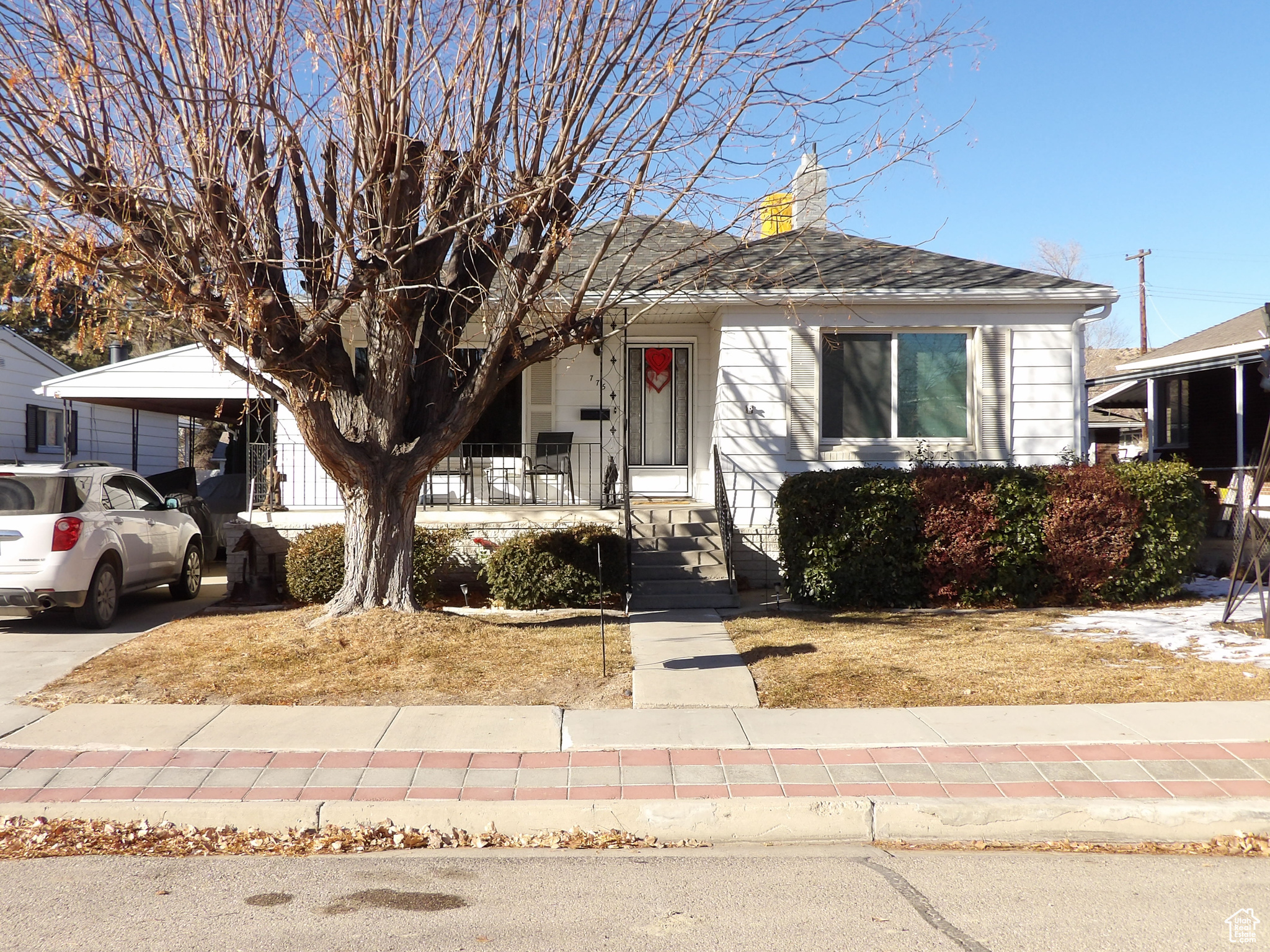 View of front of property with a carport and covered porch