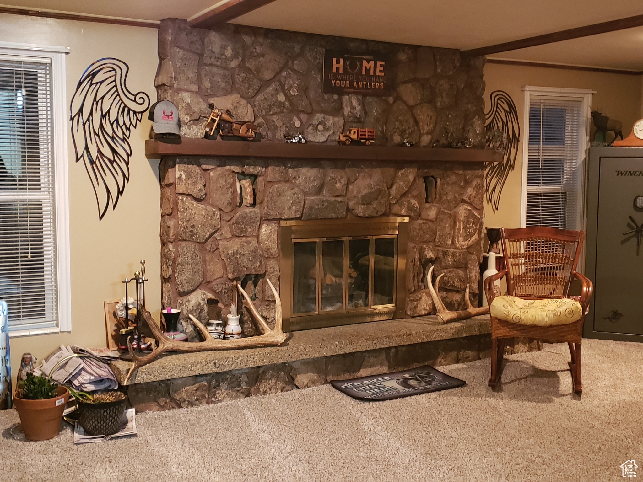 Living room with a fireplace and carpet.