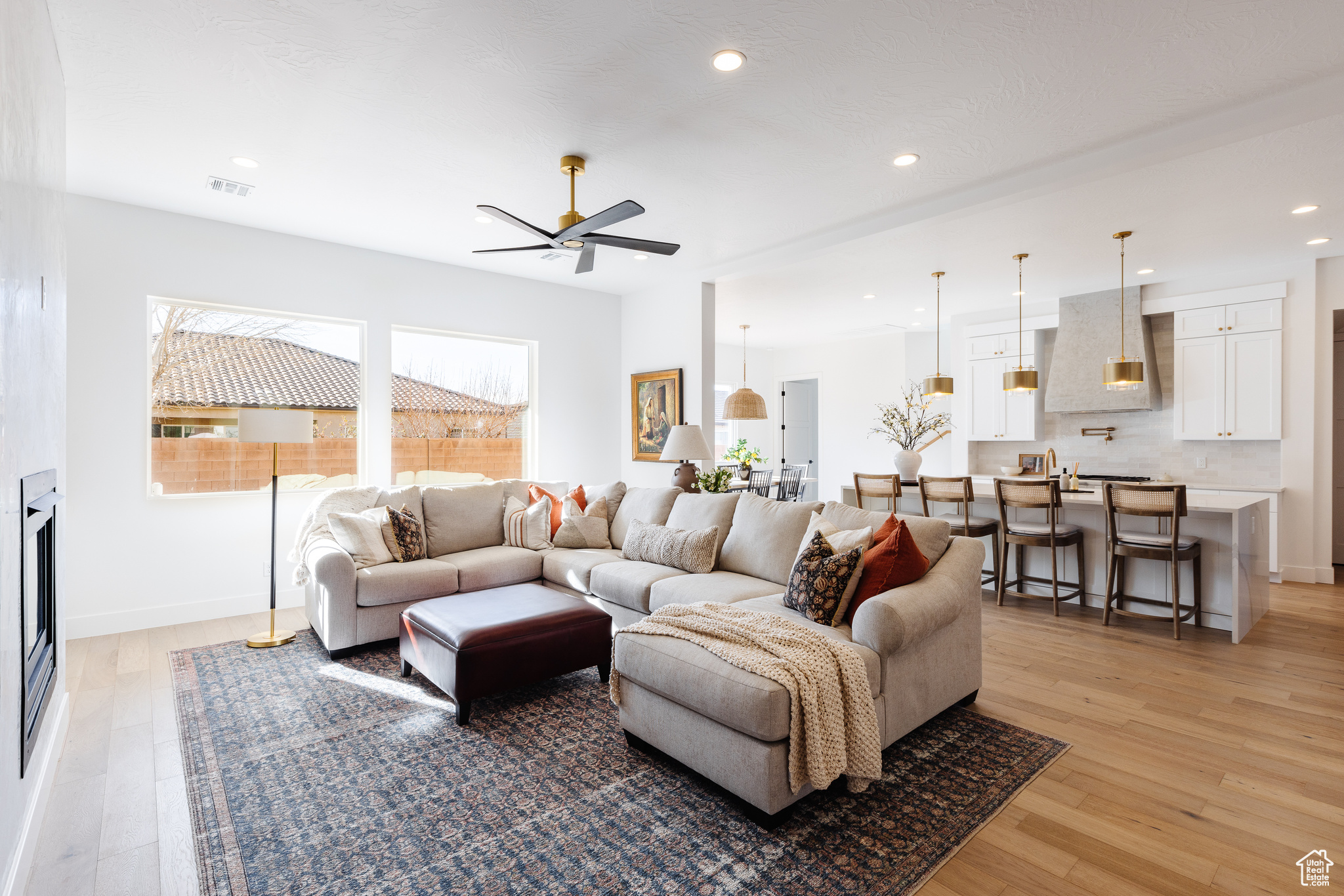 Living room featuring ceiling fan and light hardwood / wood-style floors