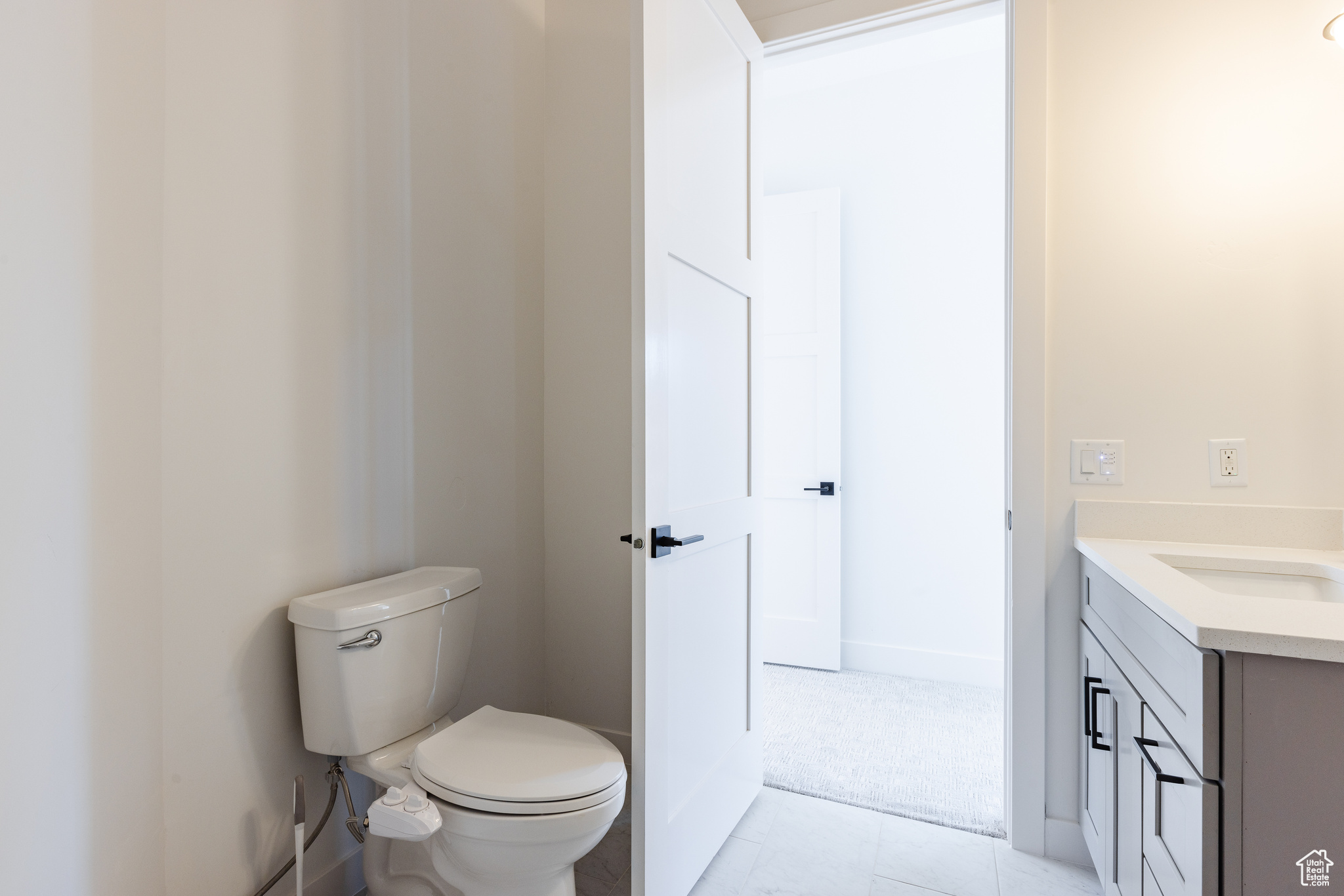 Bathroom with tile patterned floors, vanity, and toilet