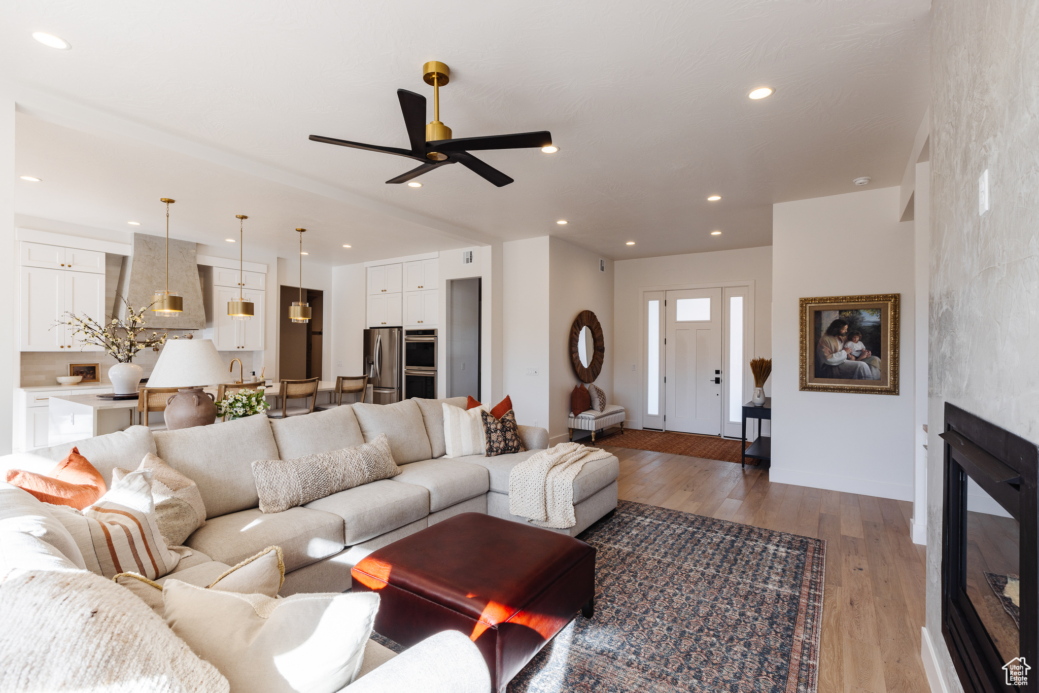 Living room with light hardwood / wood-style floors and ceiling fan