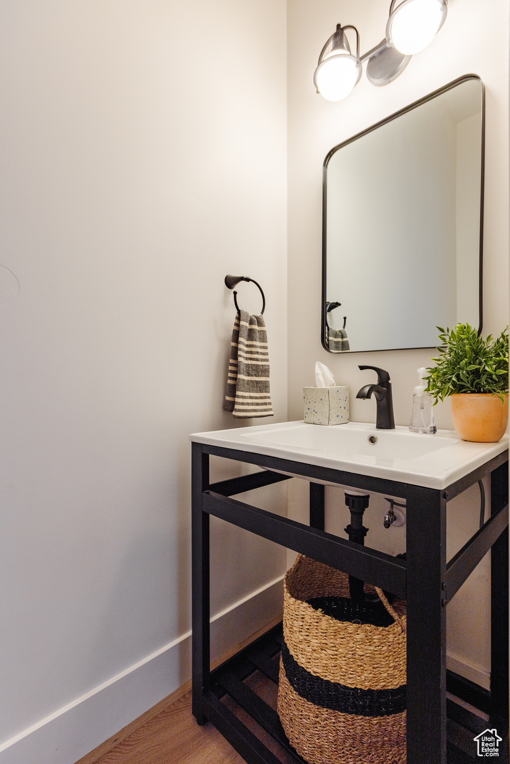 Bathroom with hardwood / wood-style floors and vanity