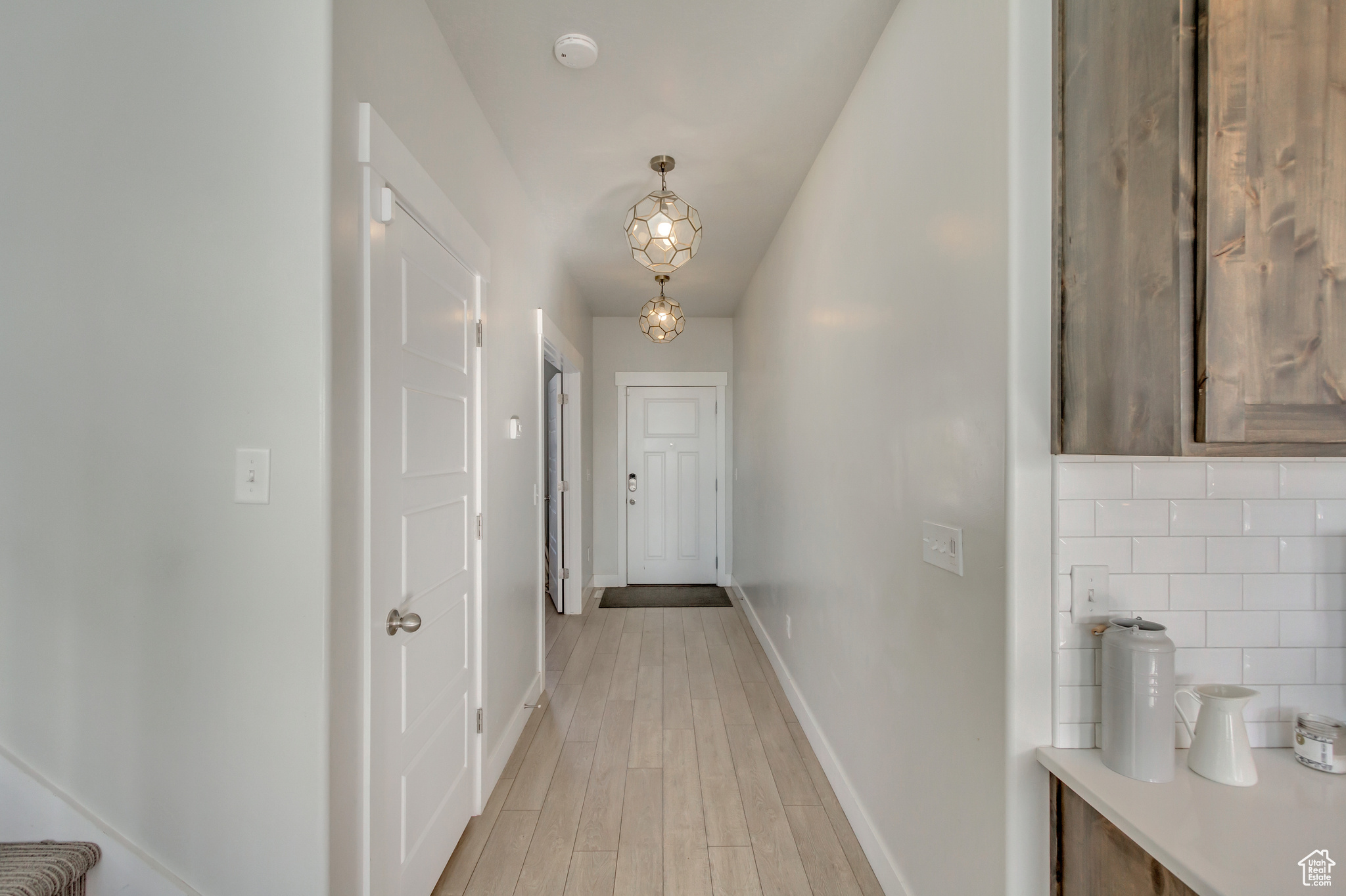Corridor featuring light wood-type flooring
