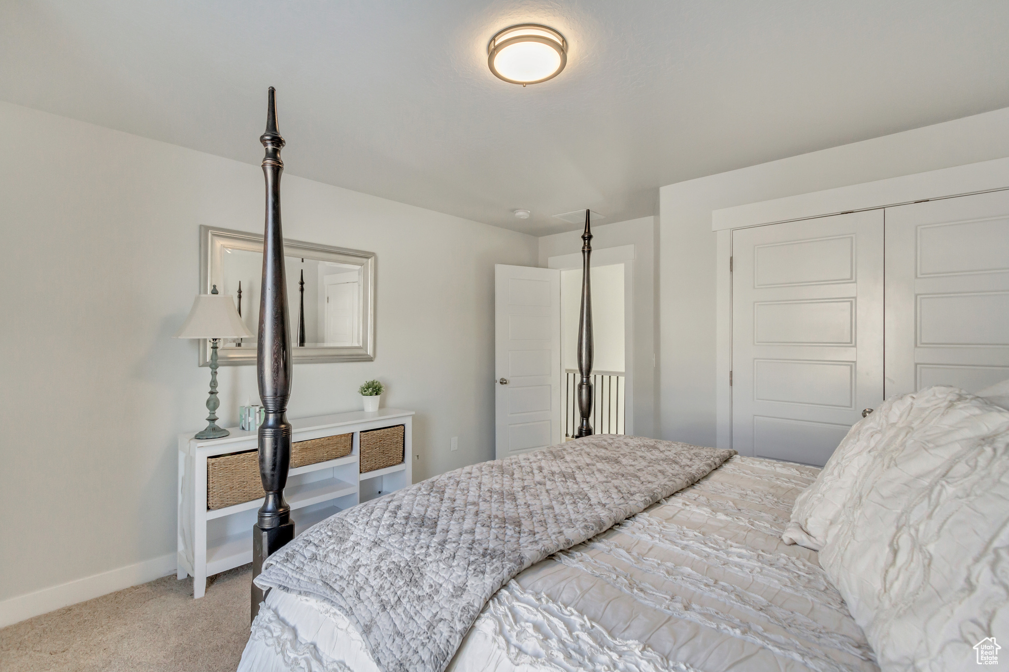 Carpeted bedroom featuring a closet
