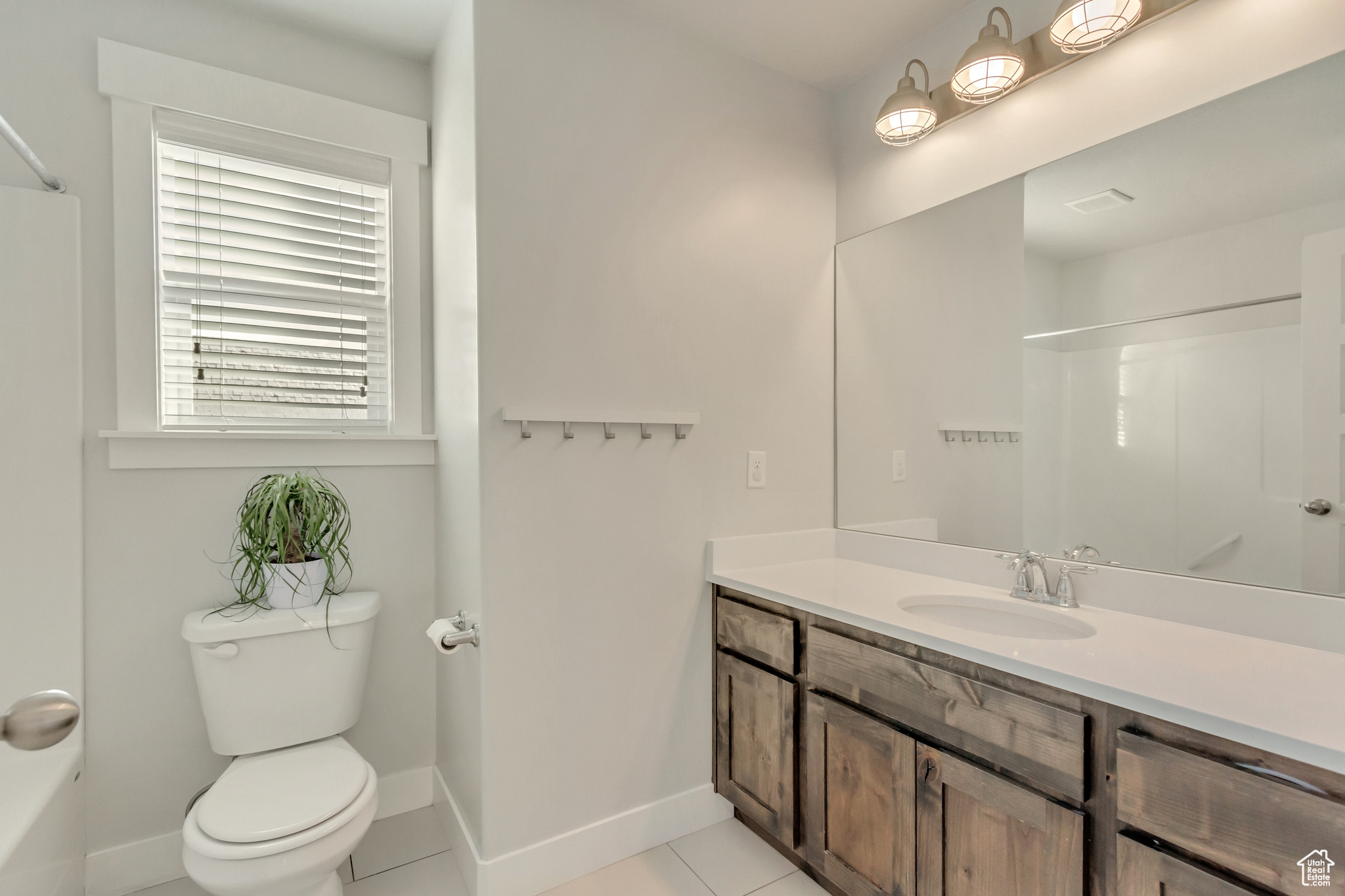 Bathroom with vanity, tile patterned flooring, and toilet