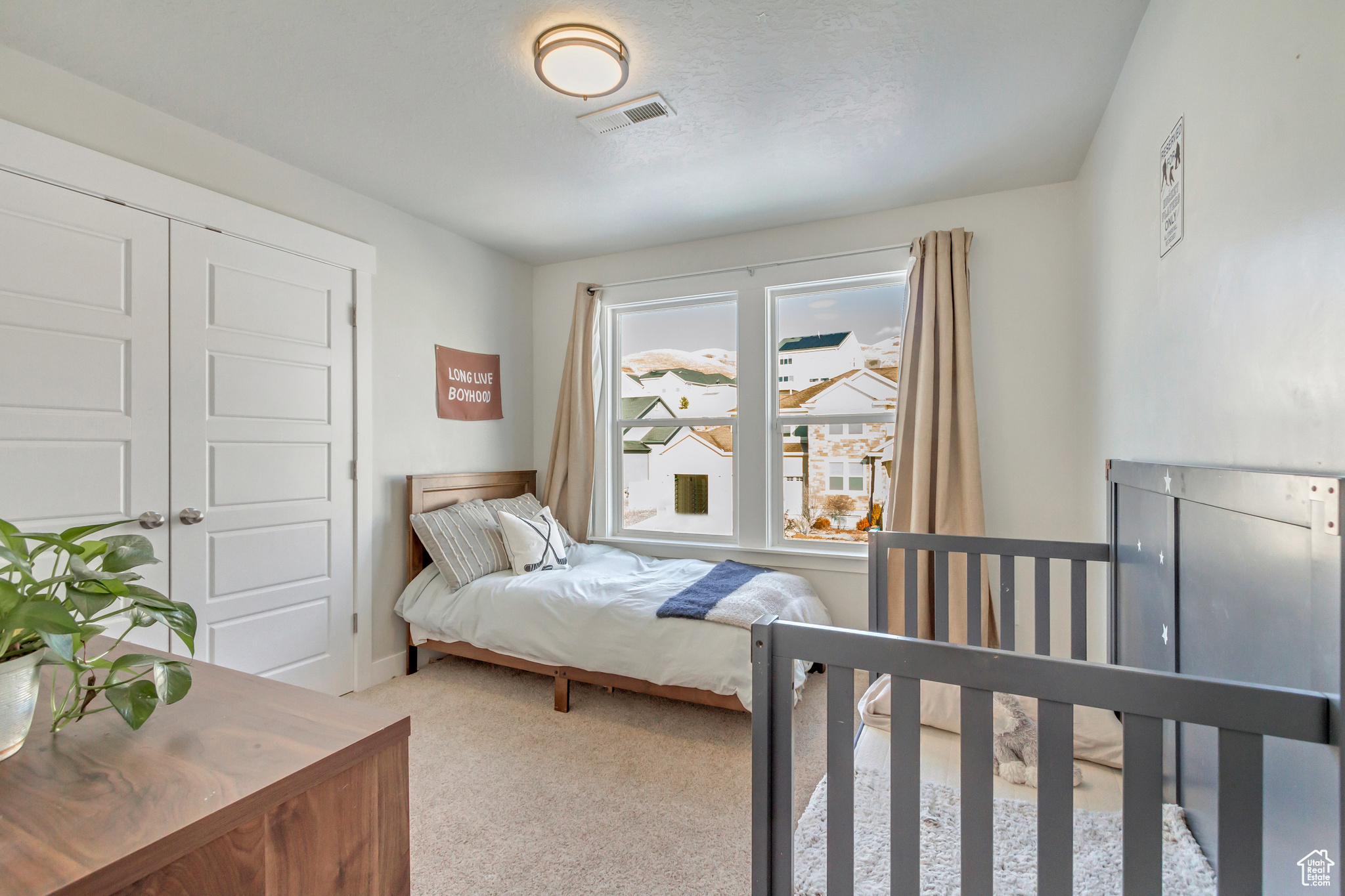 Carpeted bedroom with a closet