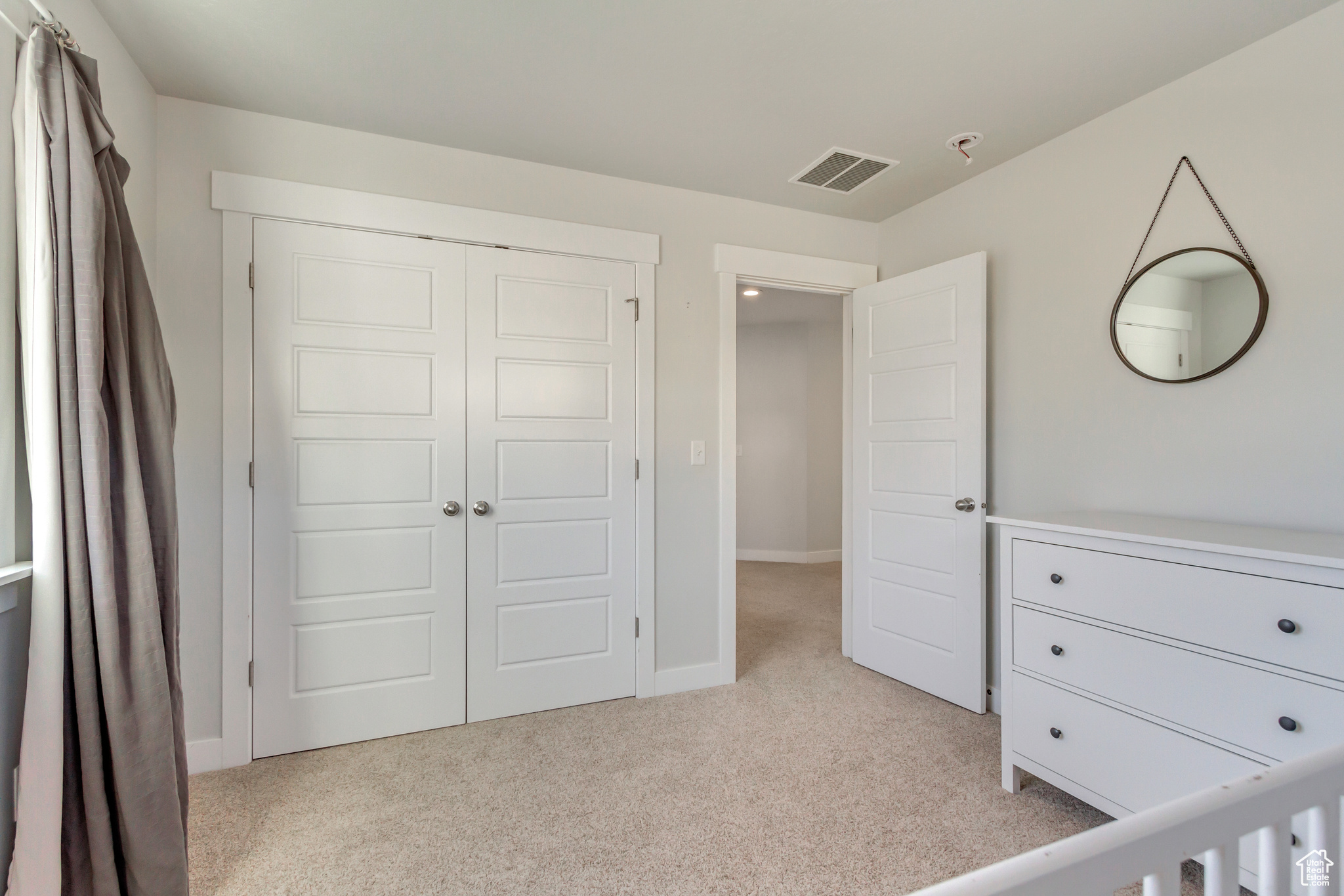 Carpeted bedroom with a closet