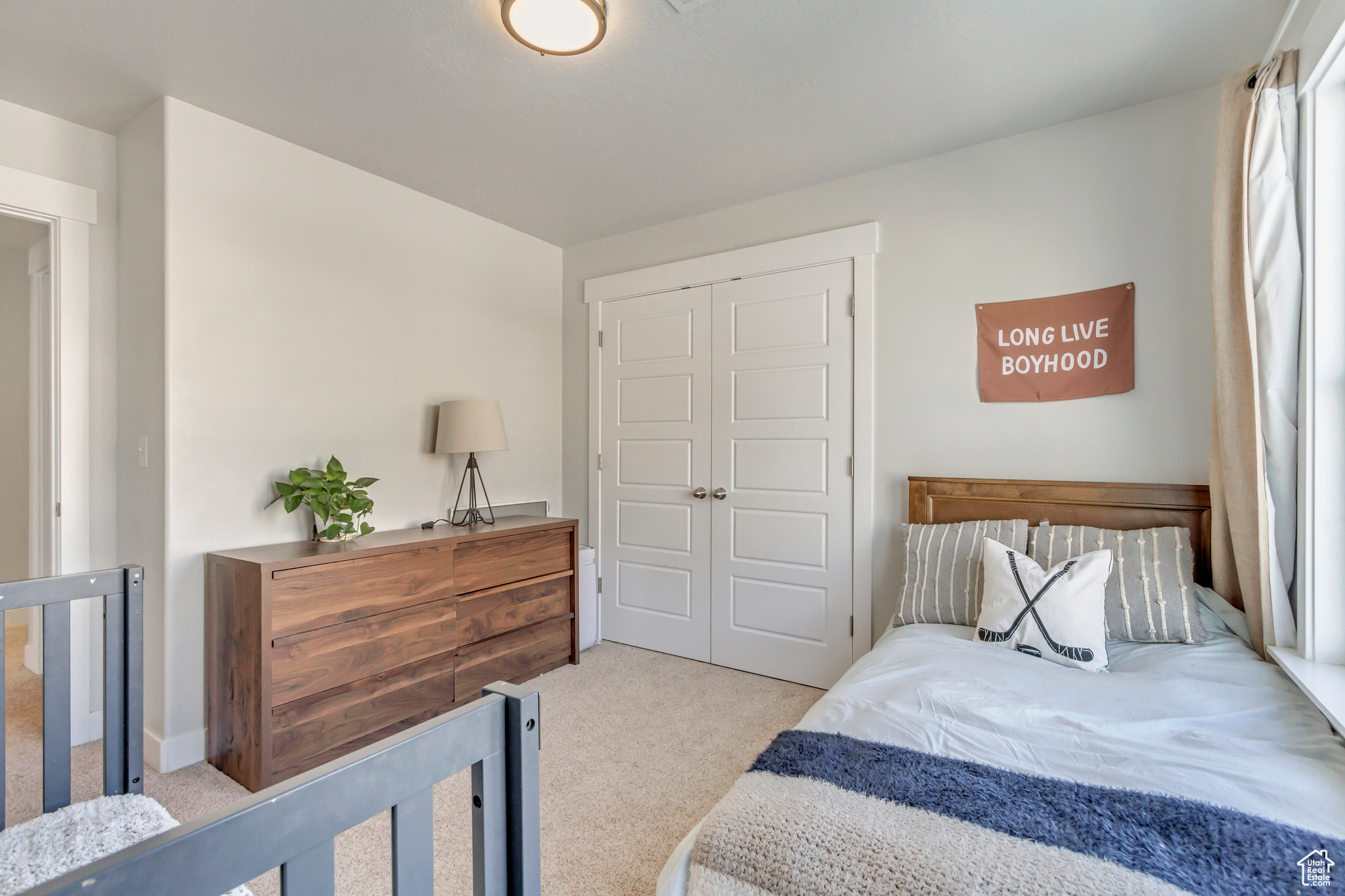 Bedroom featuring a closet and light carpet