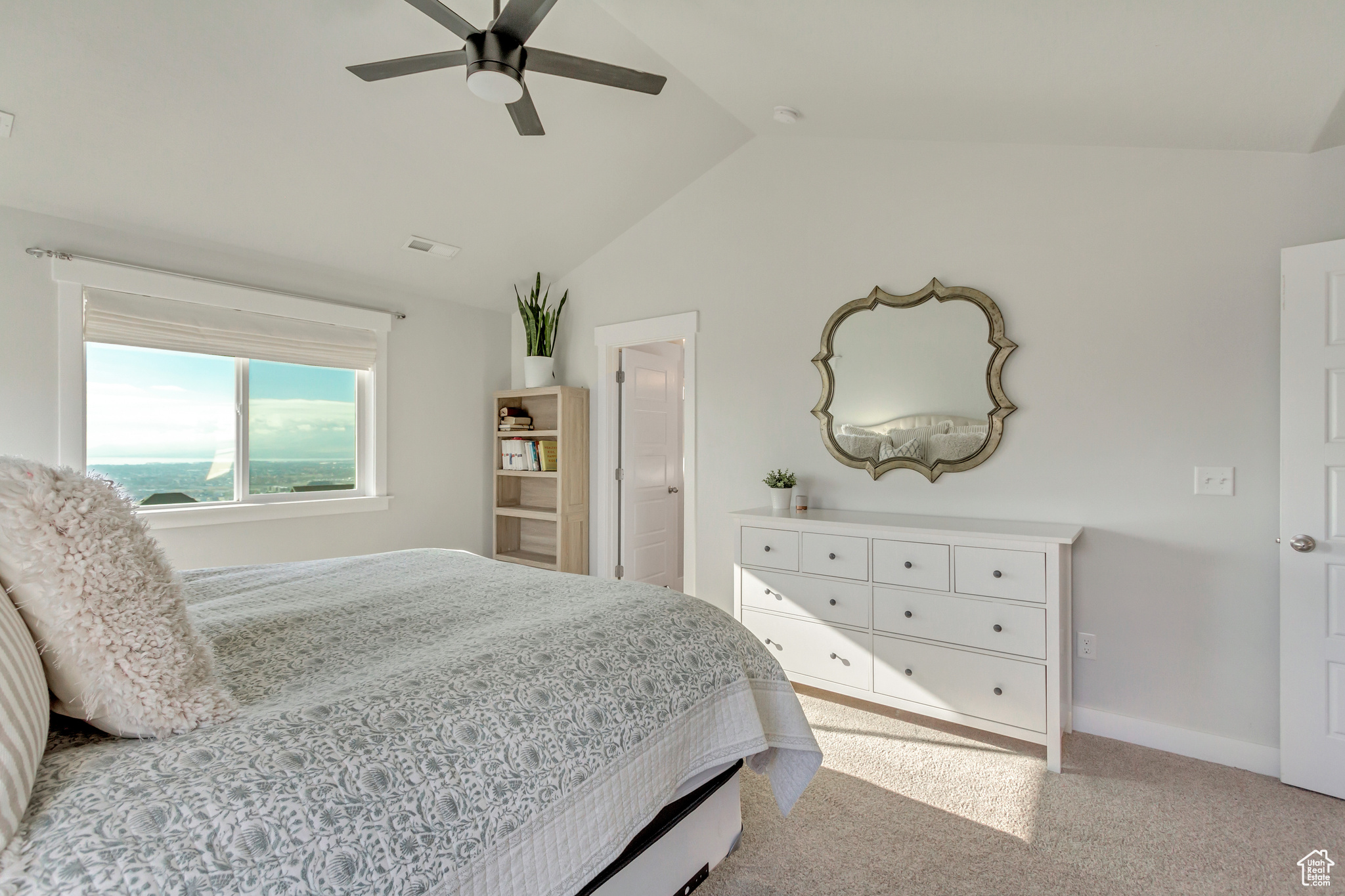 Bedroom featuring lofted ceiling, ceiling fan, and light carpet