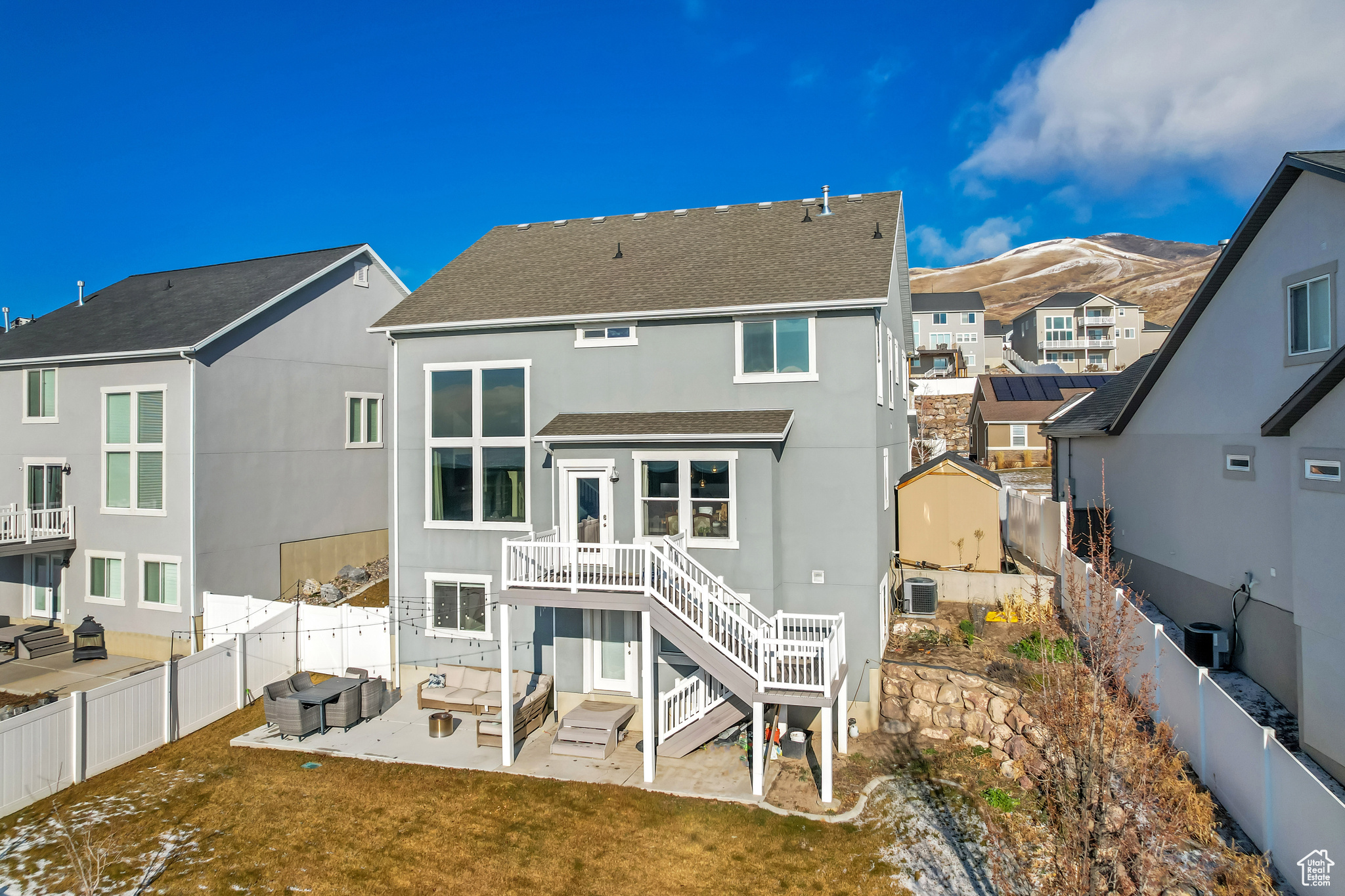 Rear view of house featuring a yard, a mountain view, an outdoor hangout area, and a patio