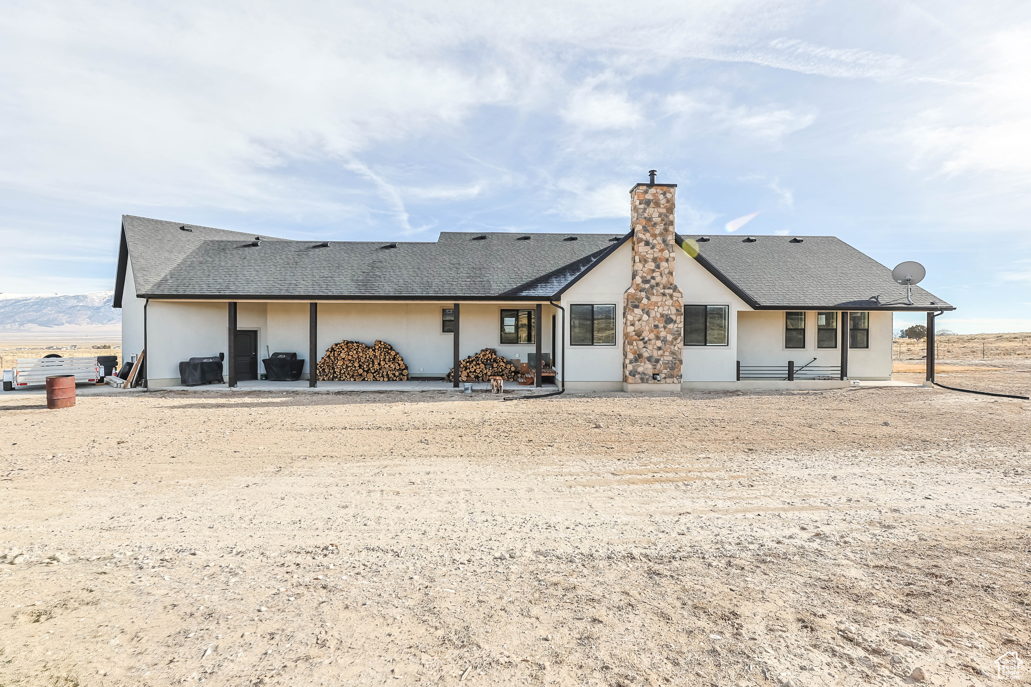 Rear view of house with a mountain view and a patio