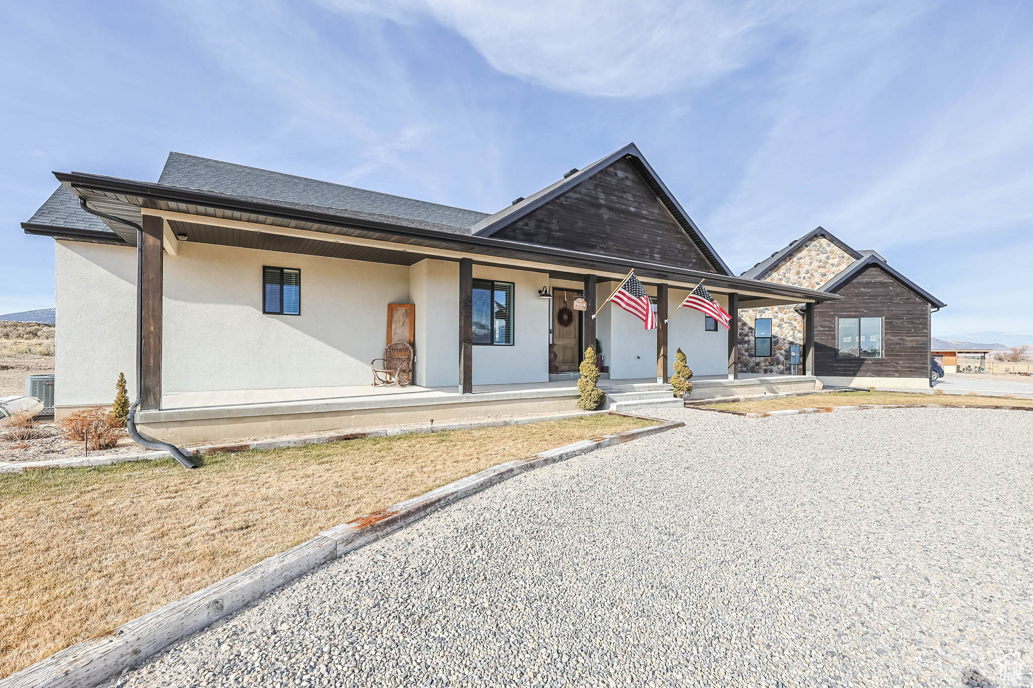 View of front of property featuring cooling unit and covered porch