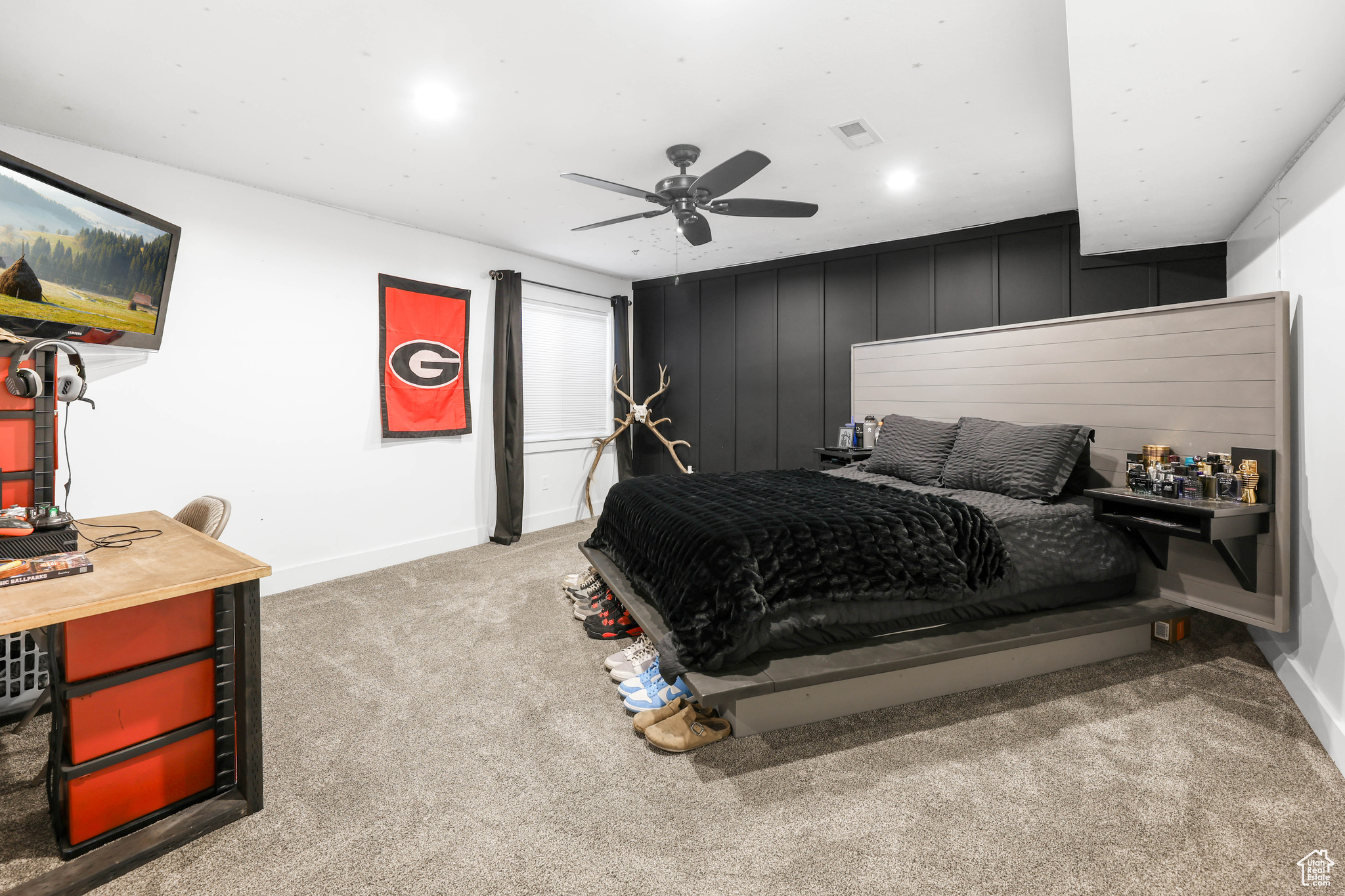 Carpeted bedroom with ceiling fan