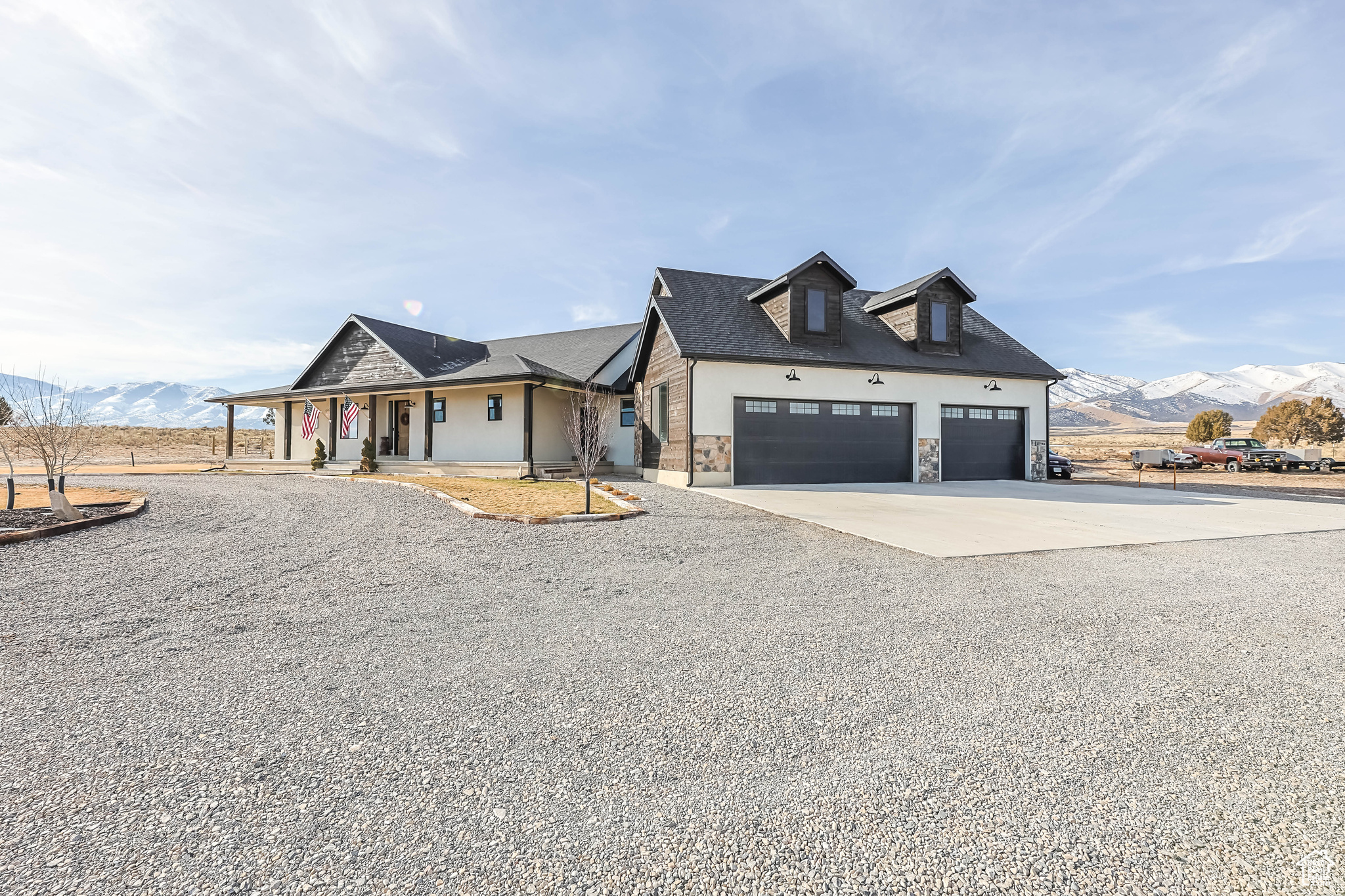 View of front of house with a mountain view, covered porch, and a garage