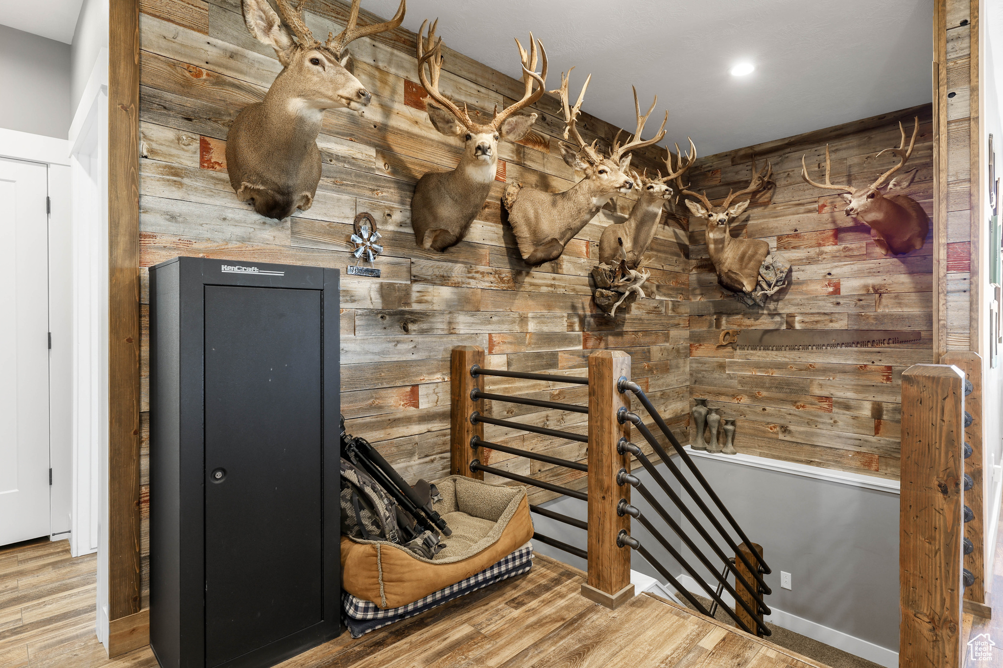 Interior space with wood walls and hardwood / wood-style flooring