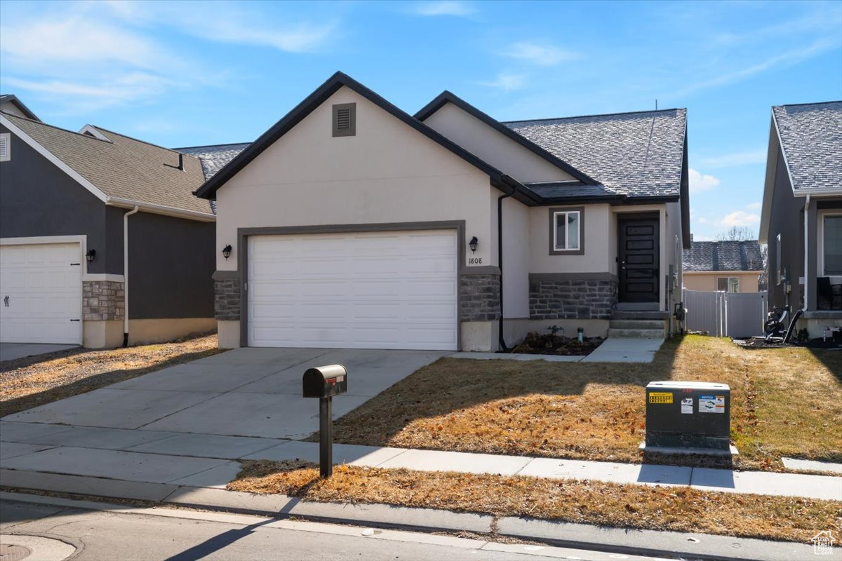 View of front facade with a garage and a front yard