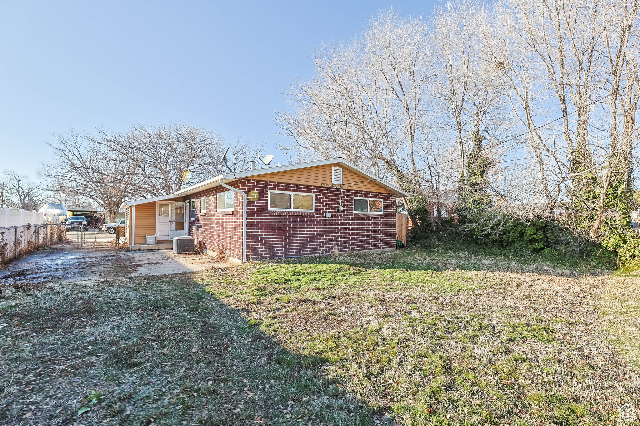View of property exterior with a lawn
