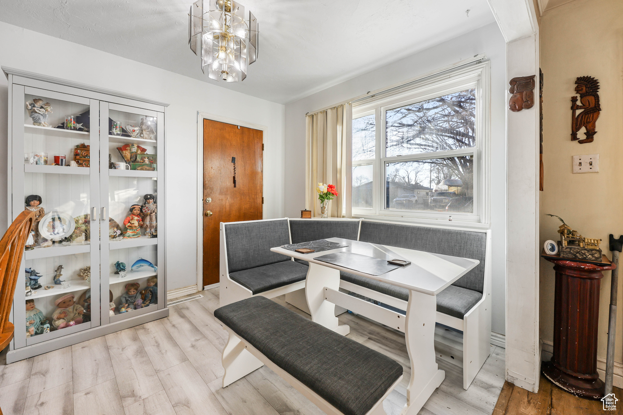 Dining room with a notable chandelier, breakfast area, and light hardwood / wood-style flooring