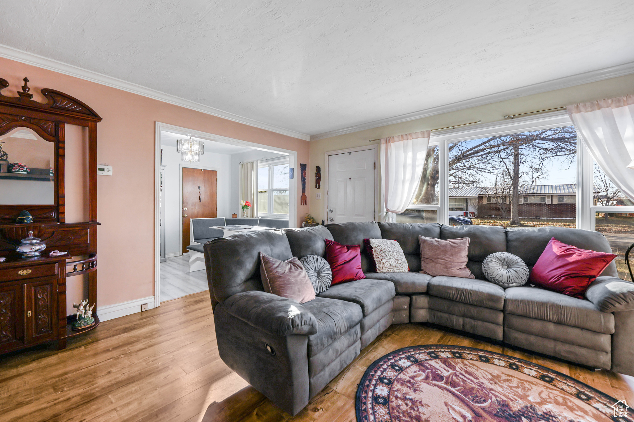Living room featuring light wood-type flooring and ornamental molding