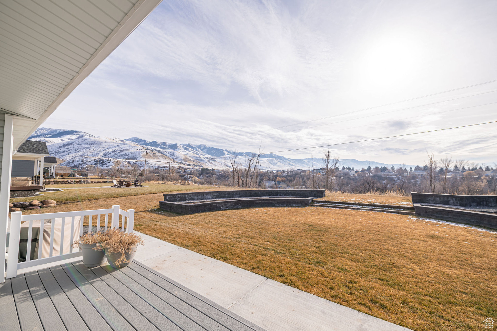 Trex deck featuring a lawn and a mountain view