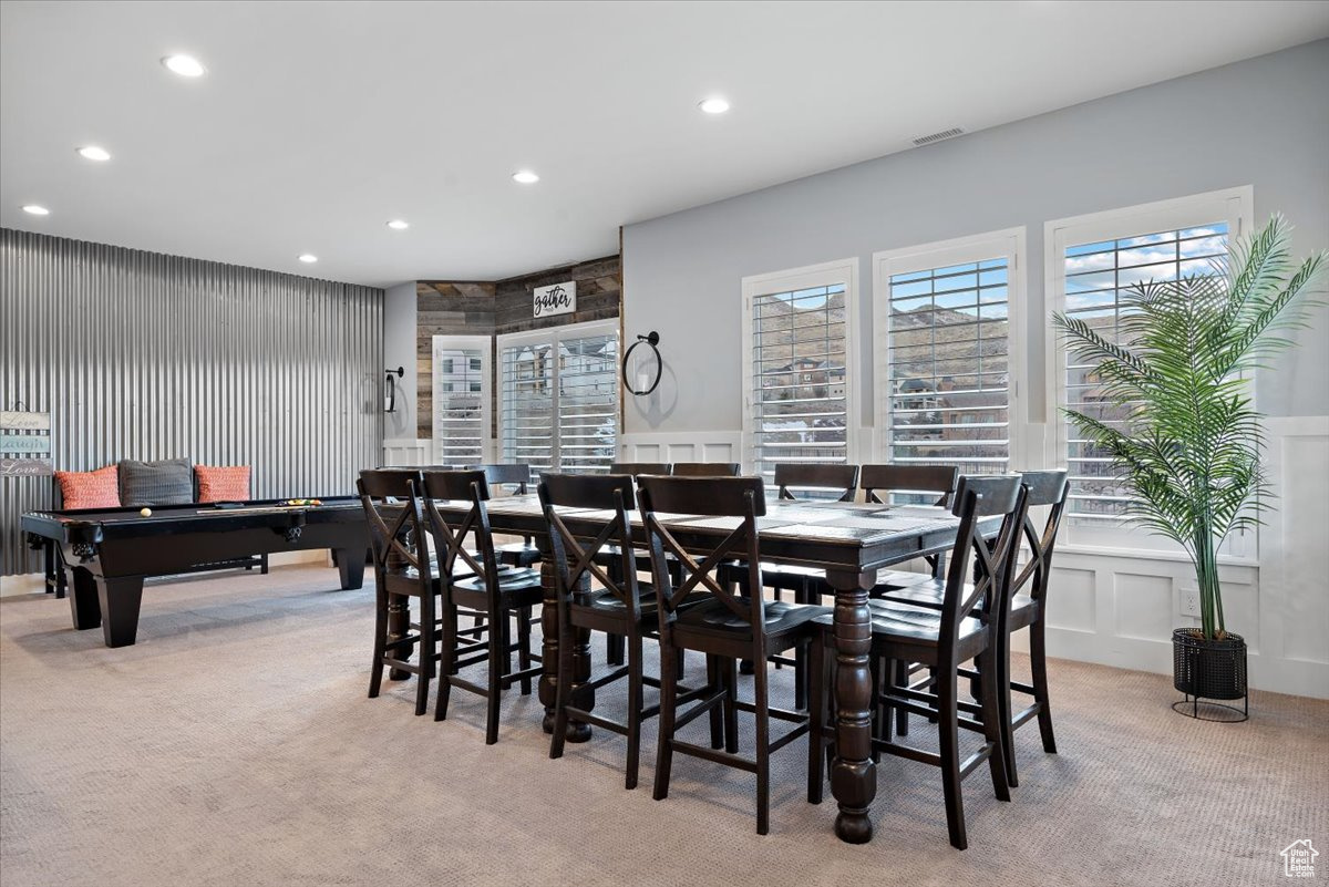 Dining space featuring light carpet