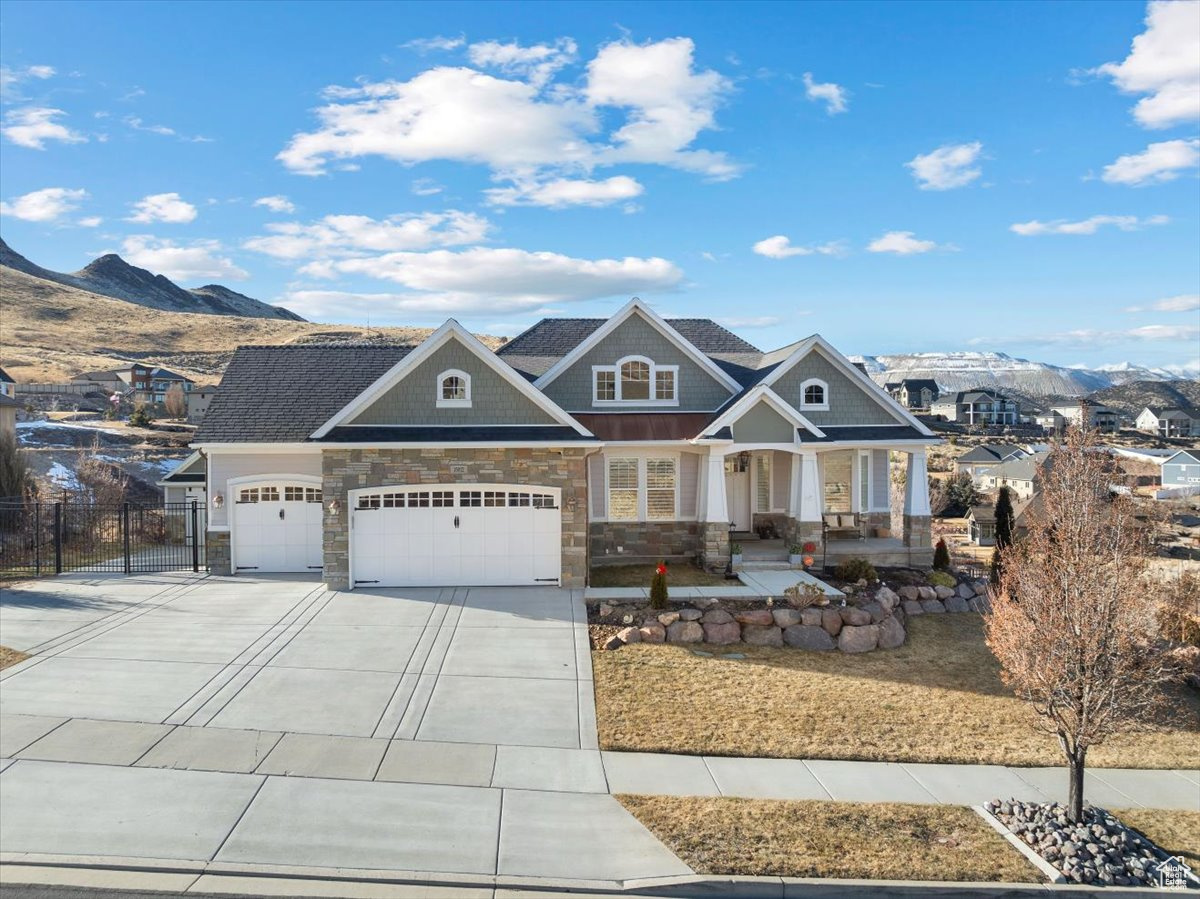 Craftsman inspired home with a mountain view, covered porch, and a garage