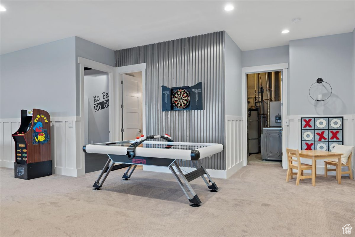 Playroom featuring water heater and light colored carpet