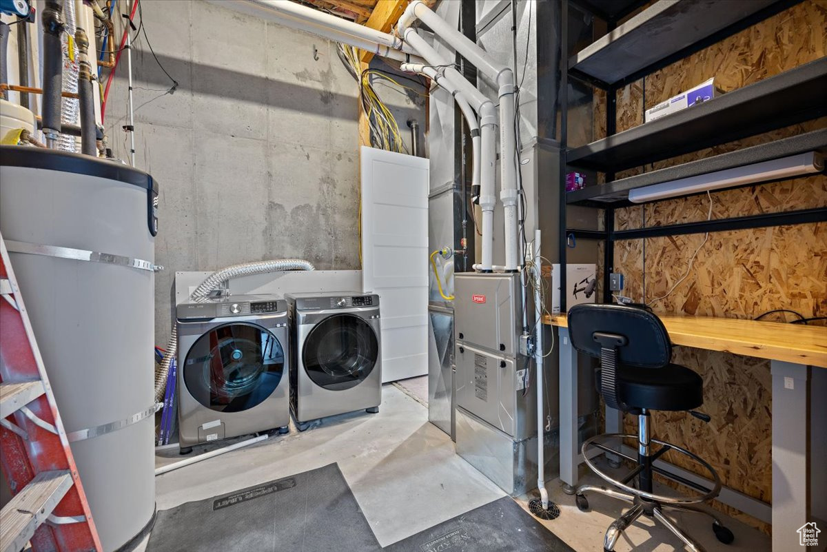 Interior space featuring independent washer and dryer and strapped water heater